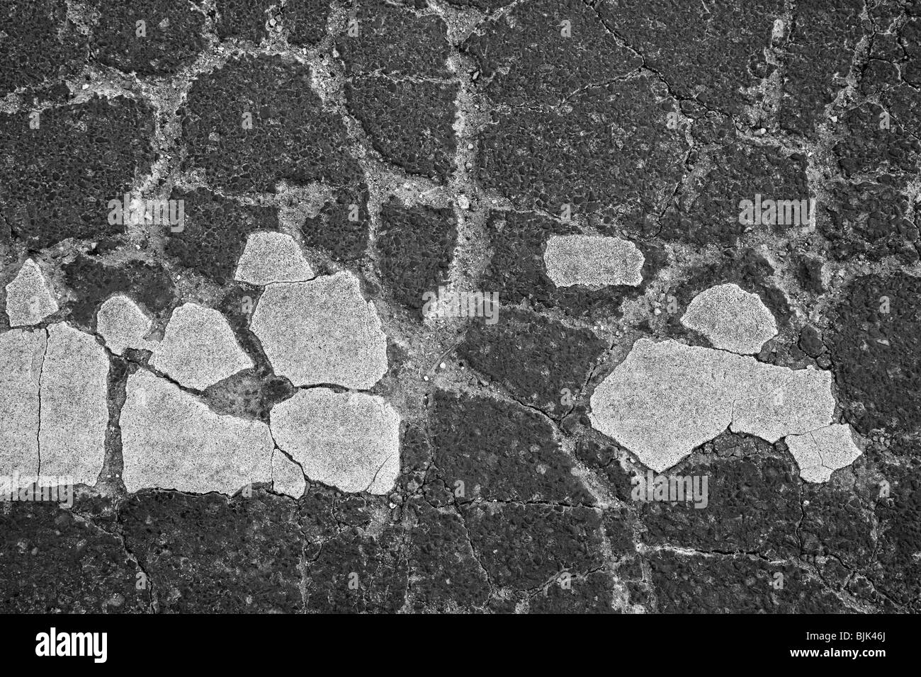 Asphalt cracked by frost and cold, potholes Stock Photo