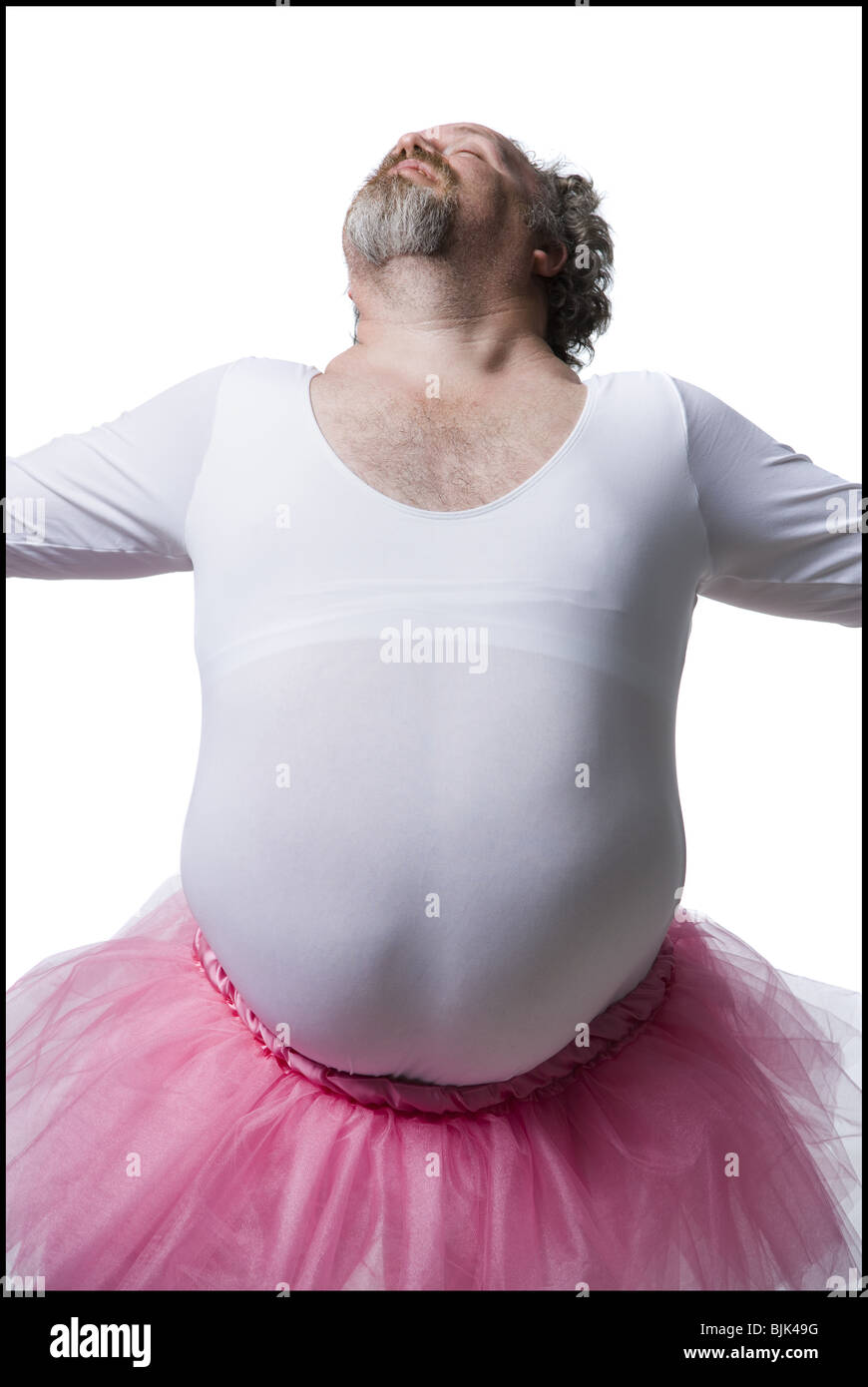 Obese man in tutu with wand dancing Stock Photo