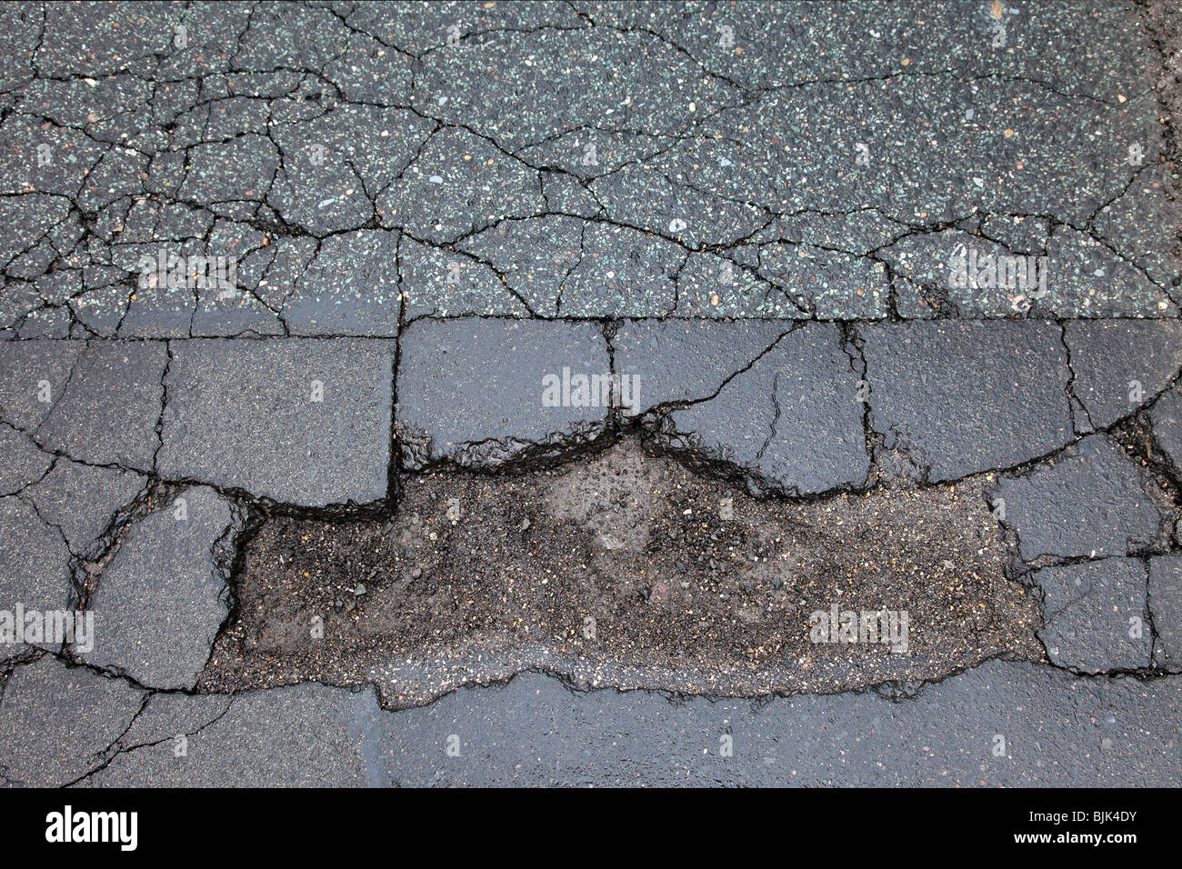 Asphalt cracked by frost and cold, potholes in Berlin, Germany, Europe Stock Photo