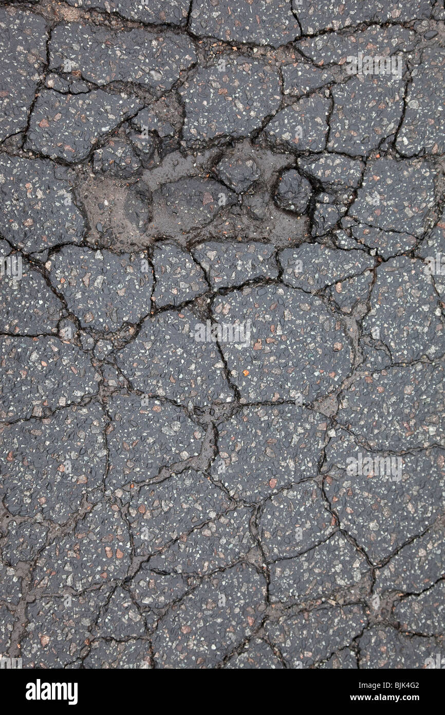 Asphalt cracked by frost and cold, potholes in Berlin, Germany, Europe Stock Photo