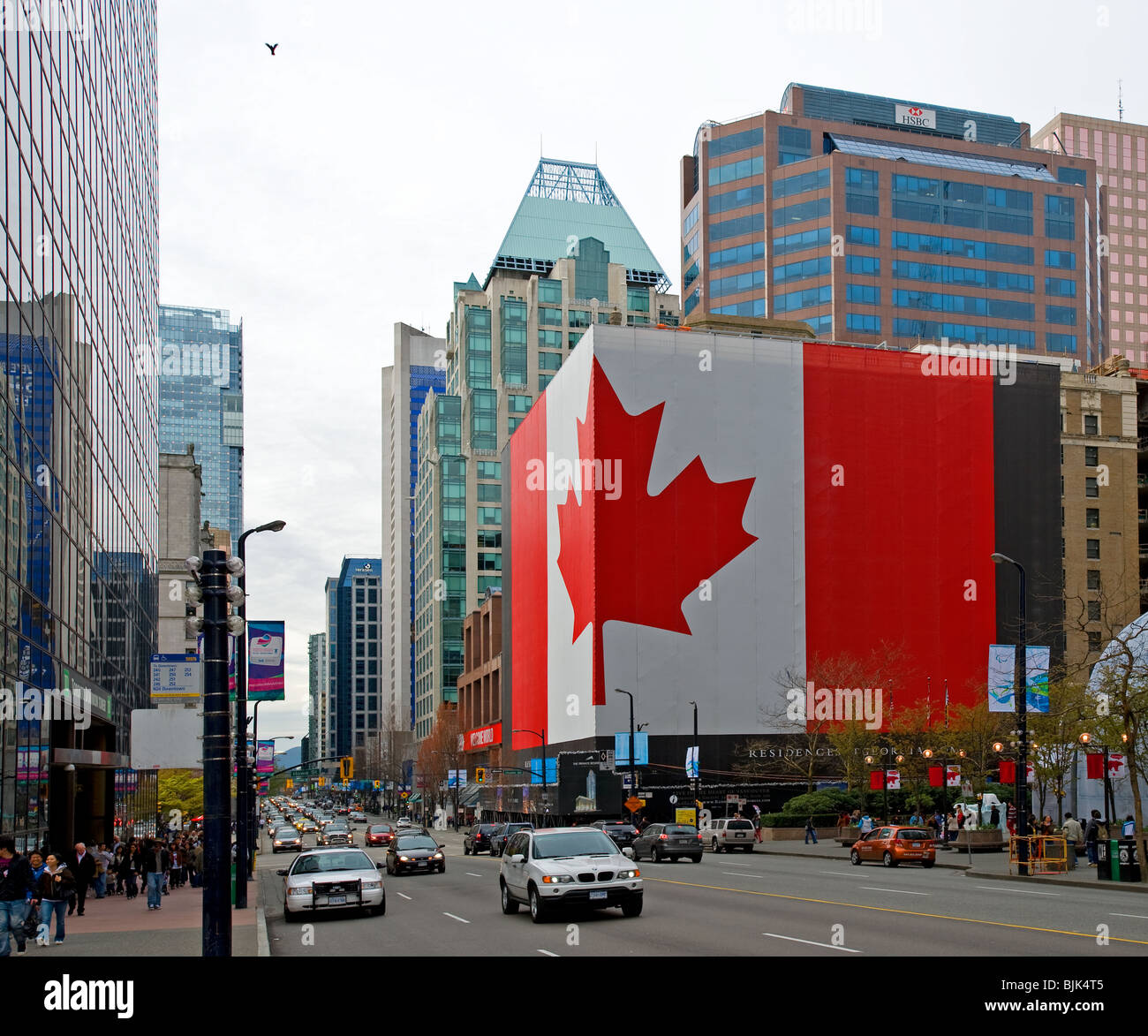 West Georgia Street downtown Vancouver, BC Canada, with a large Canadian flag erected during the 2010 Winter Olympic Games Stock Photo