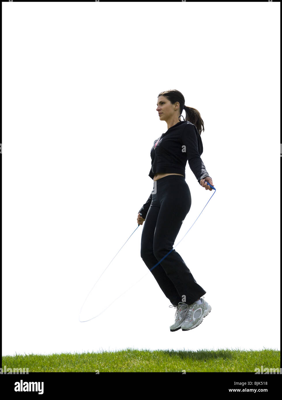 Woman skipping rope outdoors Stock Photo - Alamy