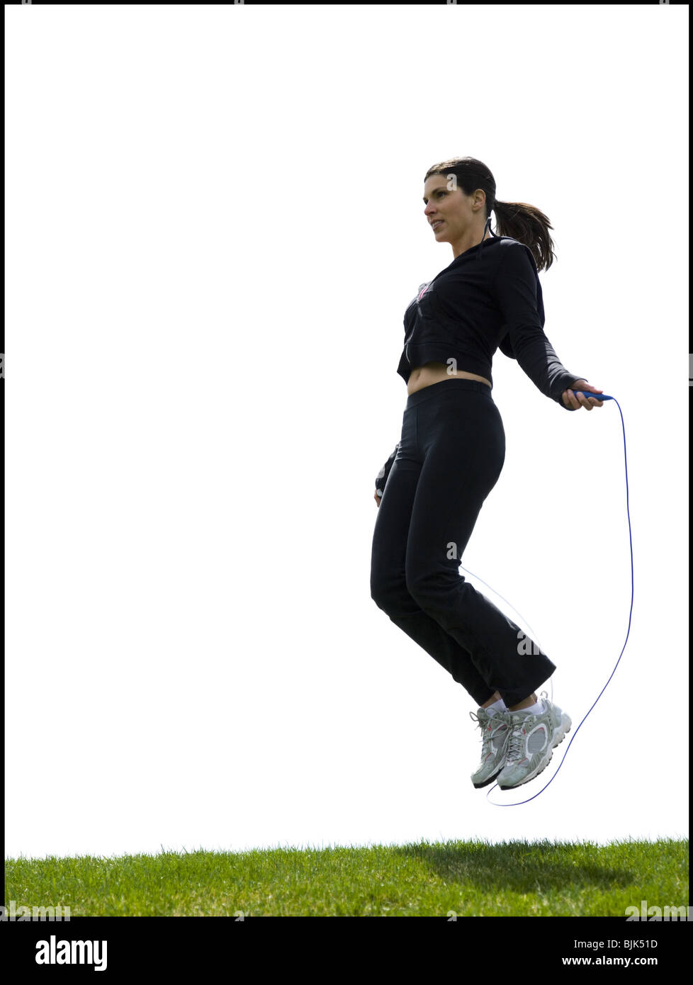 Woman skipping rope outdoors Stock Photo - Alamy