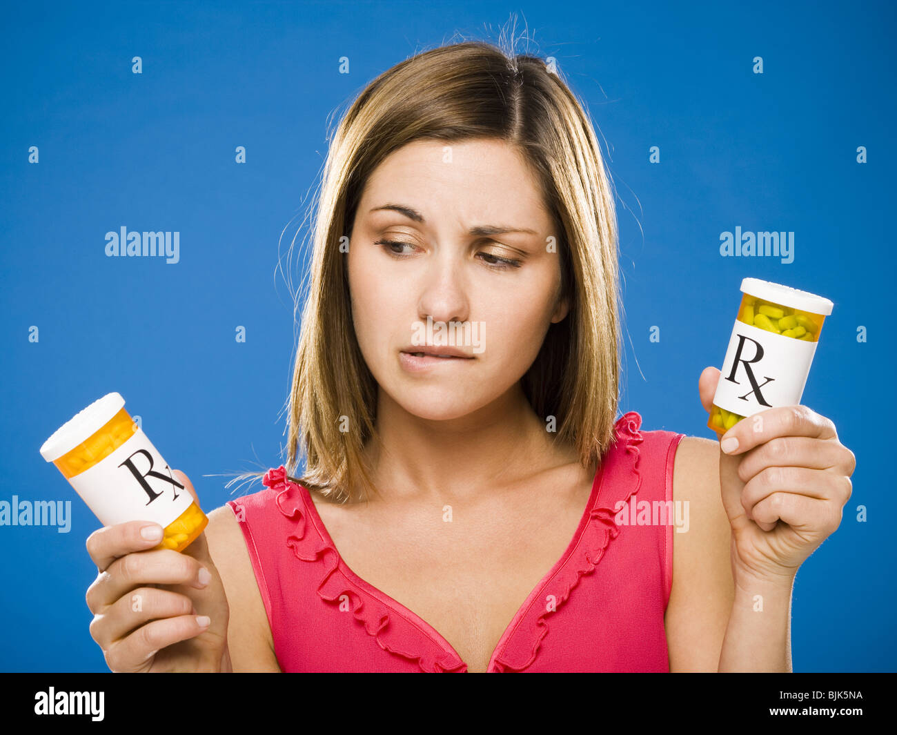 Woman holding two bottles of prescription capsules Stock Photo