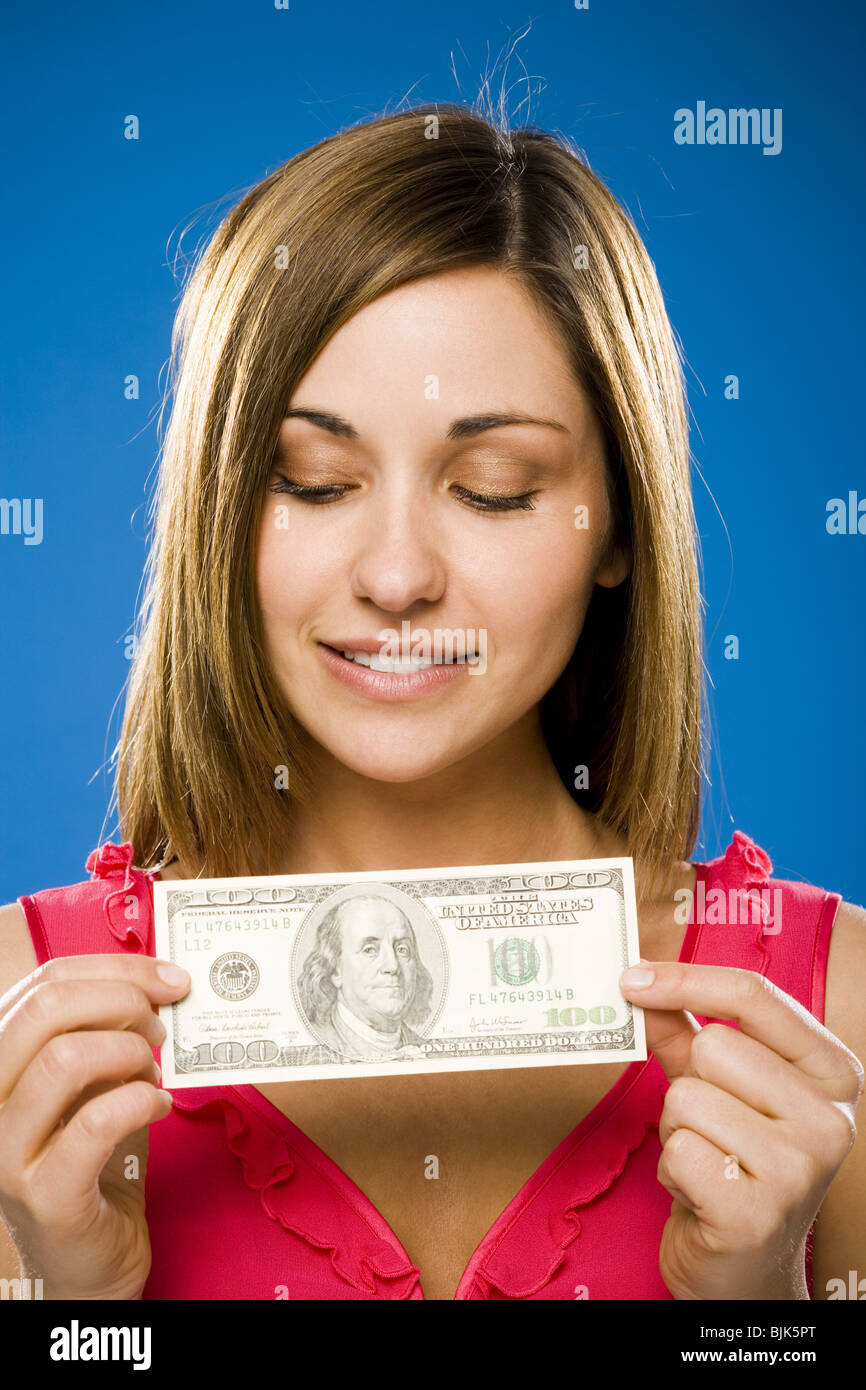 Woman holding American hundred dollar bill Stock Photo