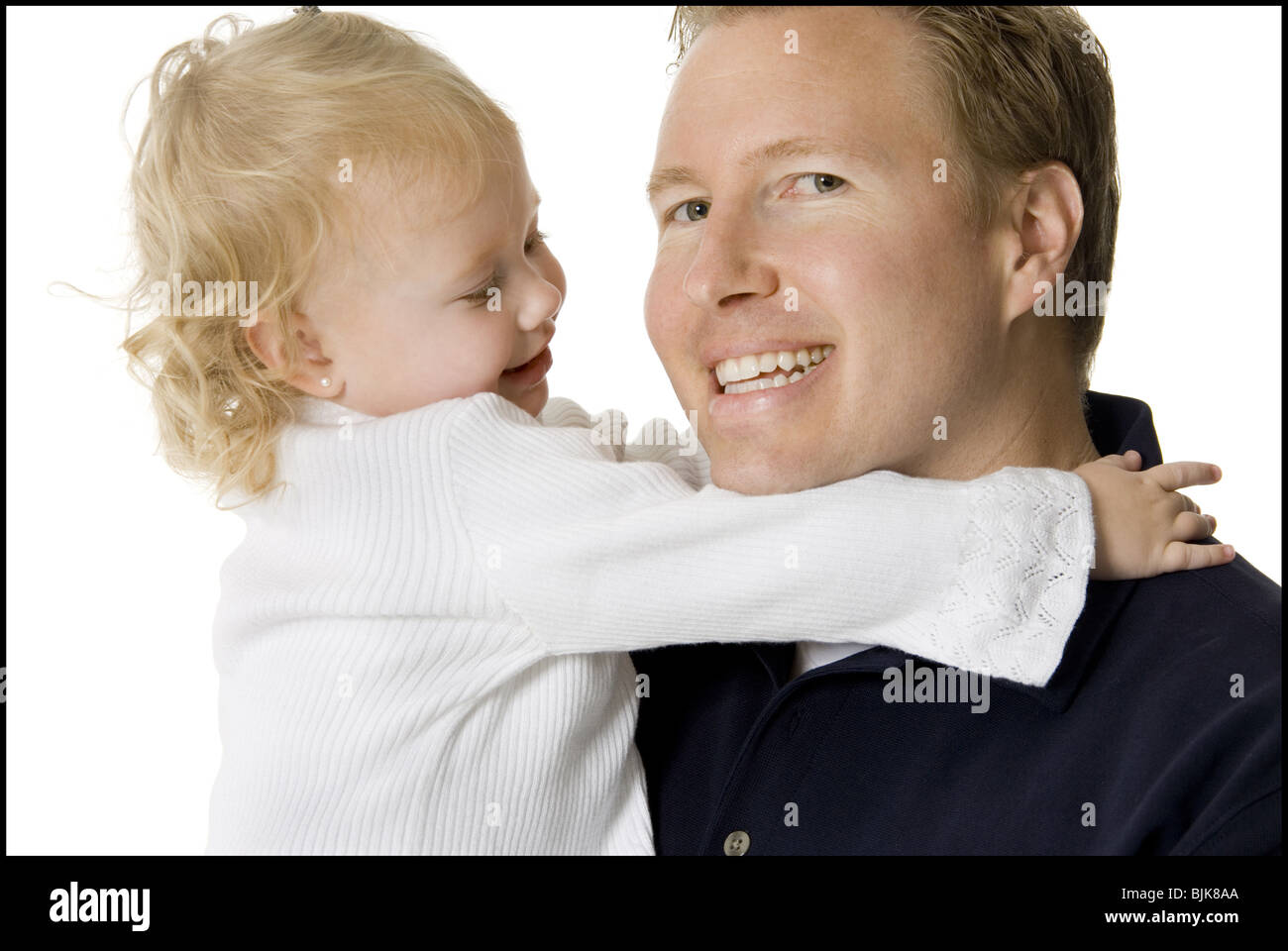Man holding and kissing girl on cheek Stock Photo