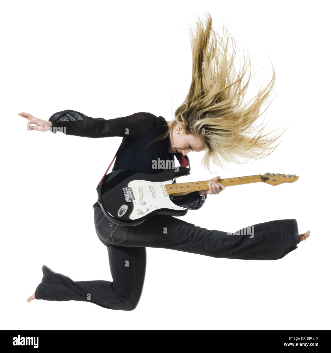 Profile of woman jumping with electric guitar Stock Photo