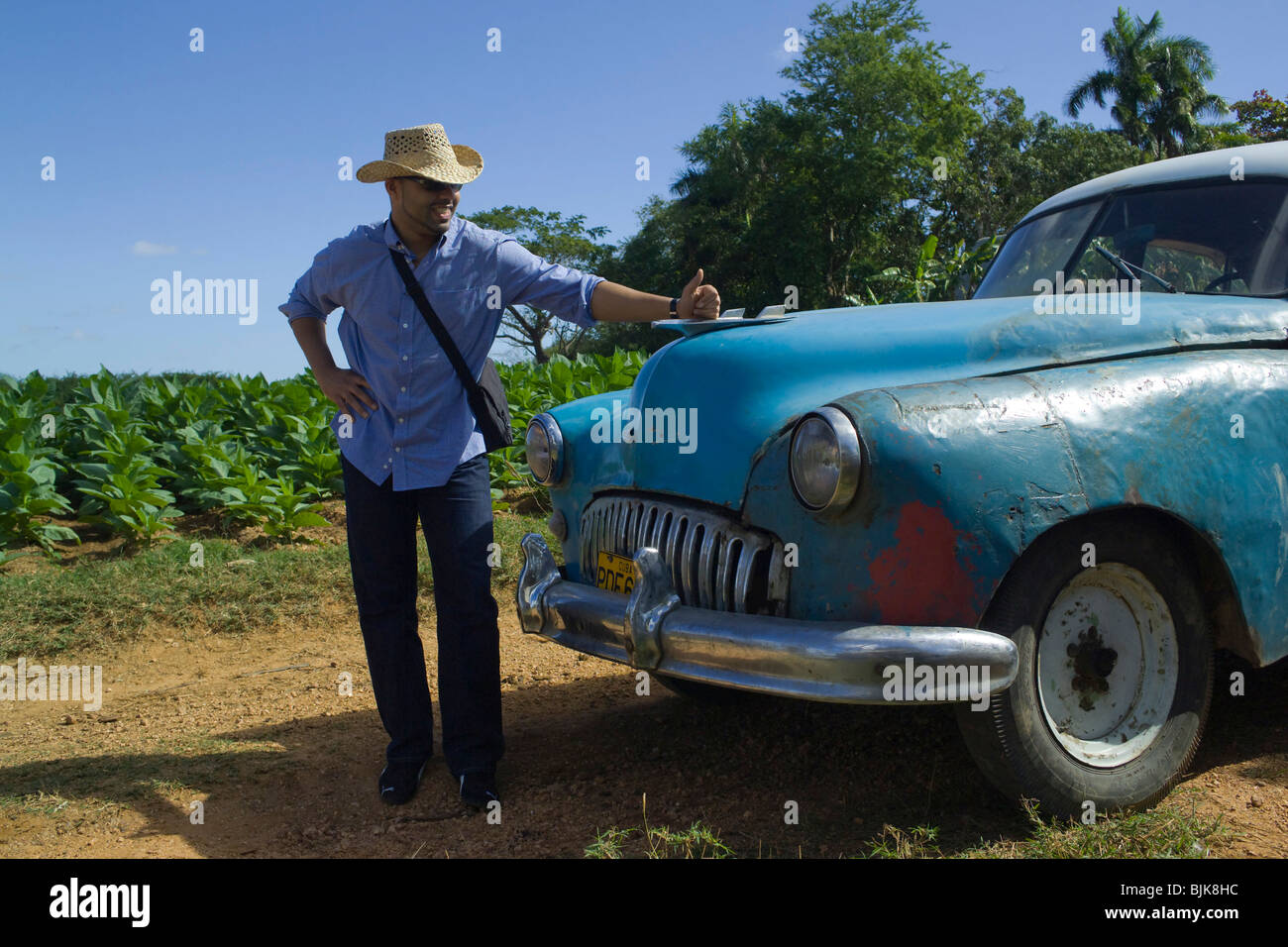 Proud owner, vintage car in Valle de Vinales, Cuba, Caribbean Stock Photo