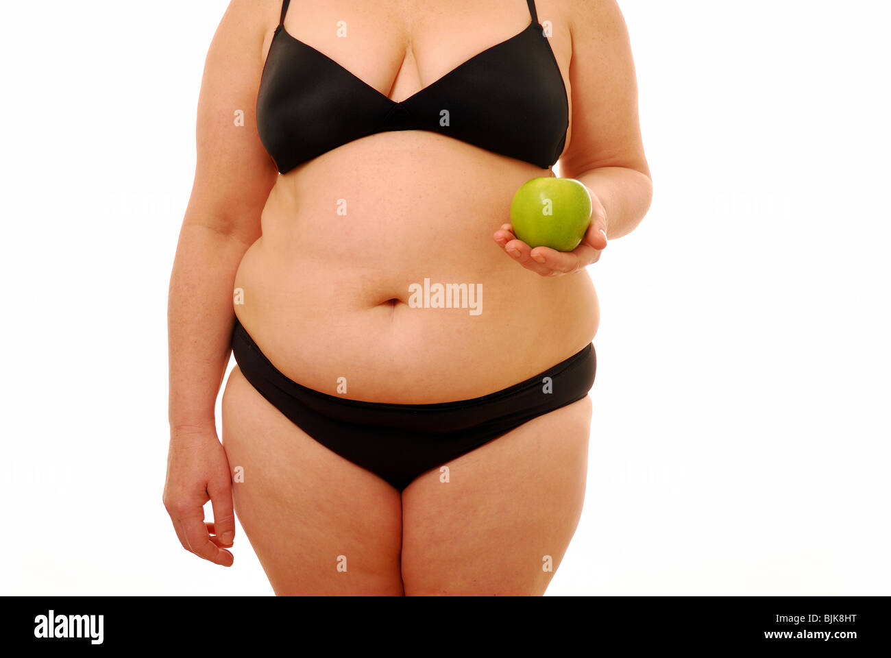 Overweight lady trying to change her food options for a healthy choice Stock Photo