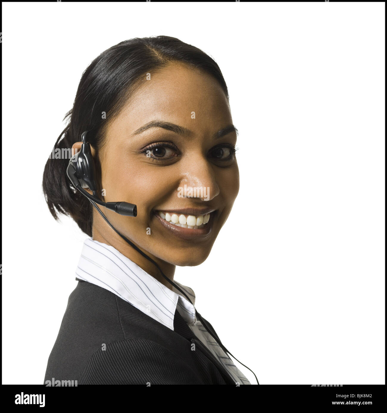 Portrait of woman with headset smiling Stock Photo