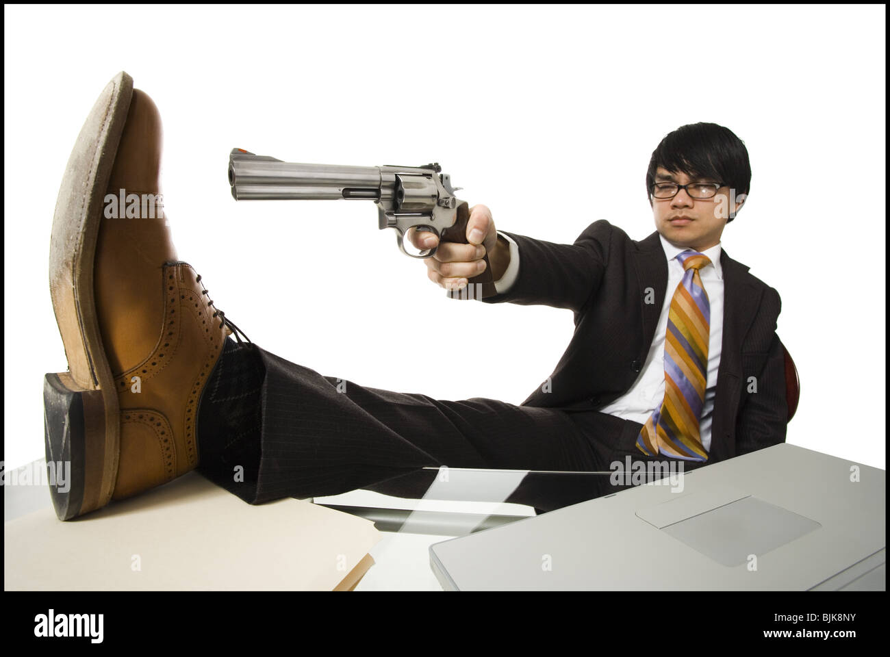 businessman-sitting-at-desk-pointing-sho