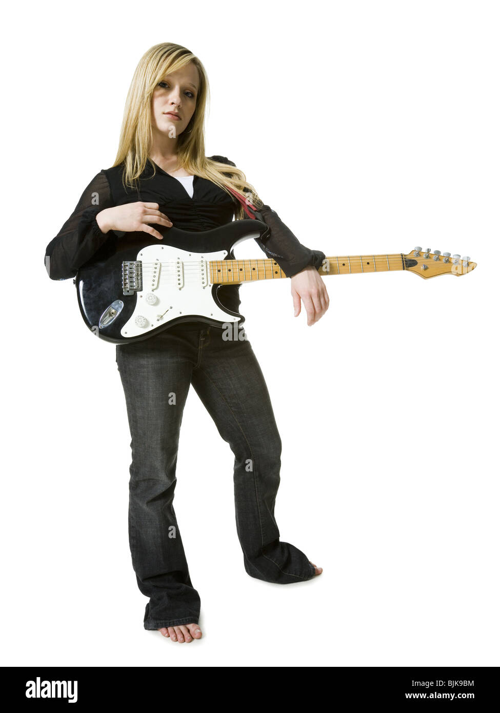Woman standing with electric guitar Stock Photo - Alamy