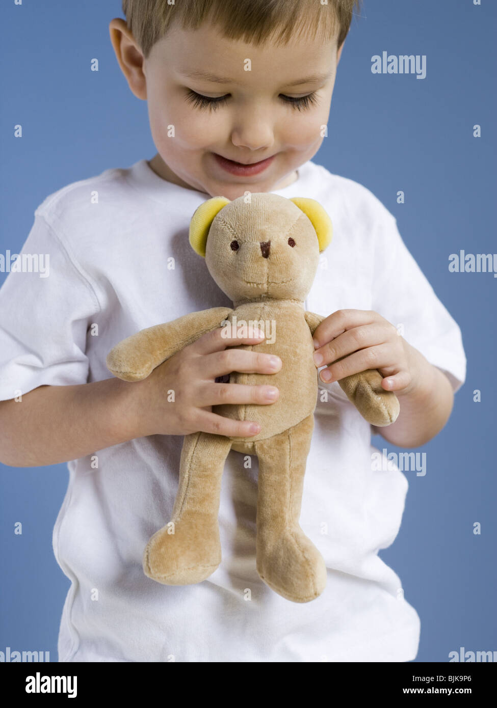 Closeup of boy holding teddy bear Stock Photo - Alamy