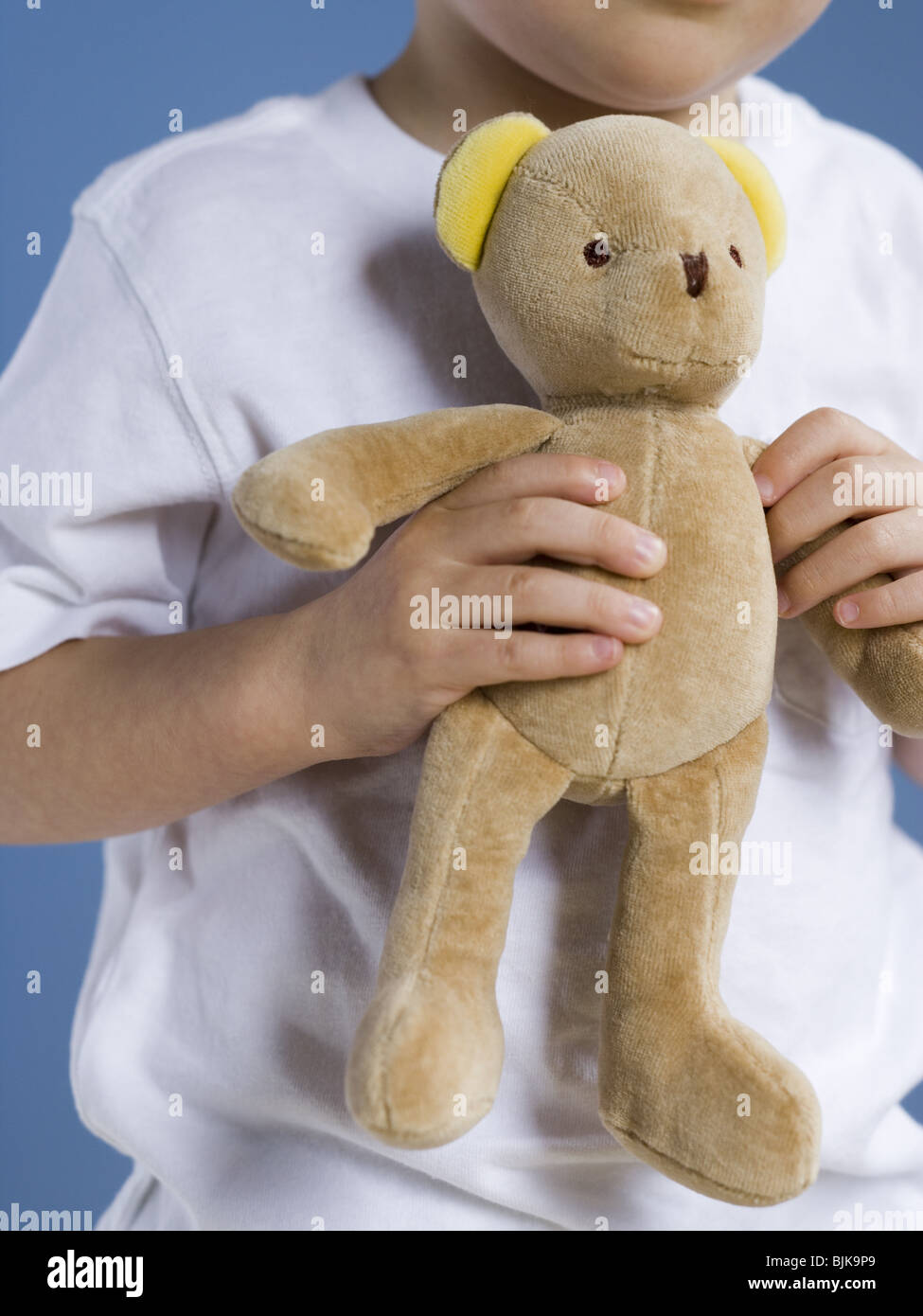 Closeup of boy holding teddy bear Stock Photo - Alamy