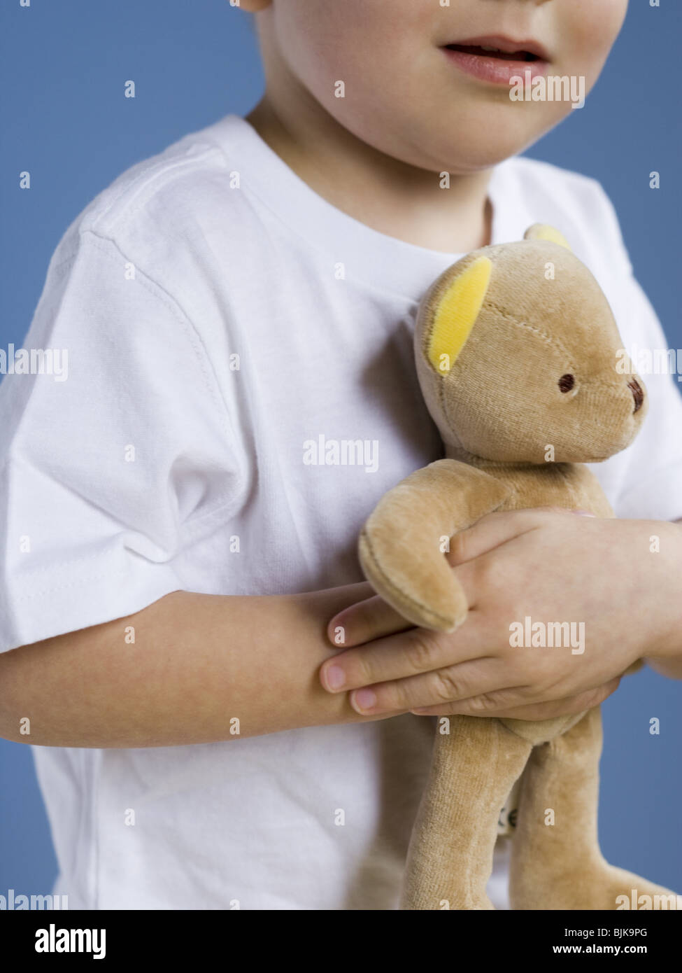 Closeup of boy holding teddy bear Stock Photo - Alamy
