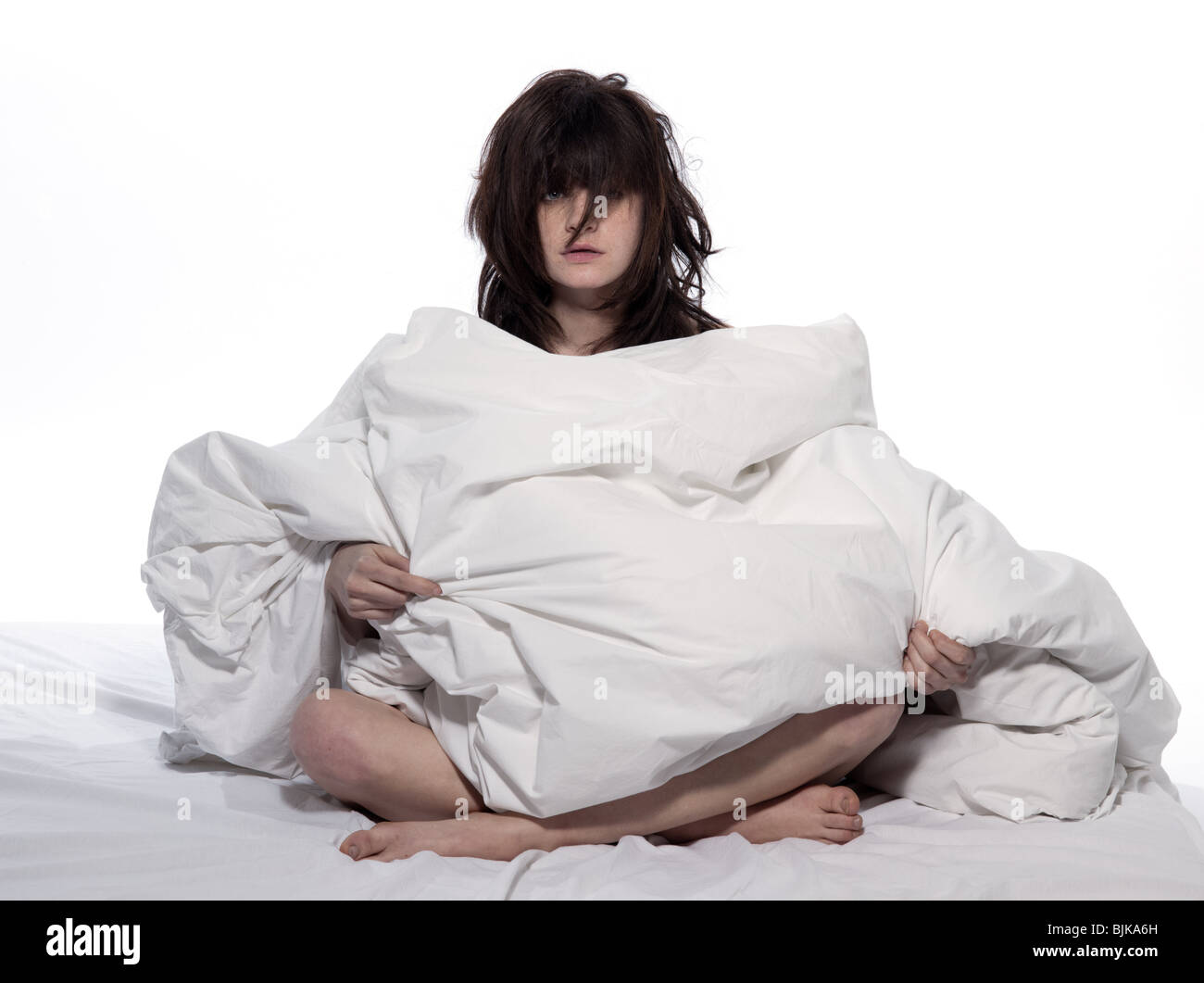 one young woman in bed awakening tired insomnia hangover in a white