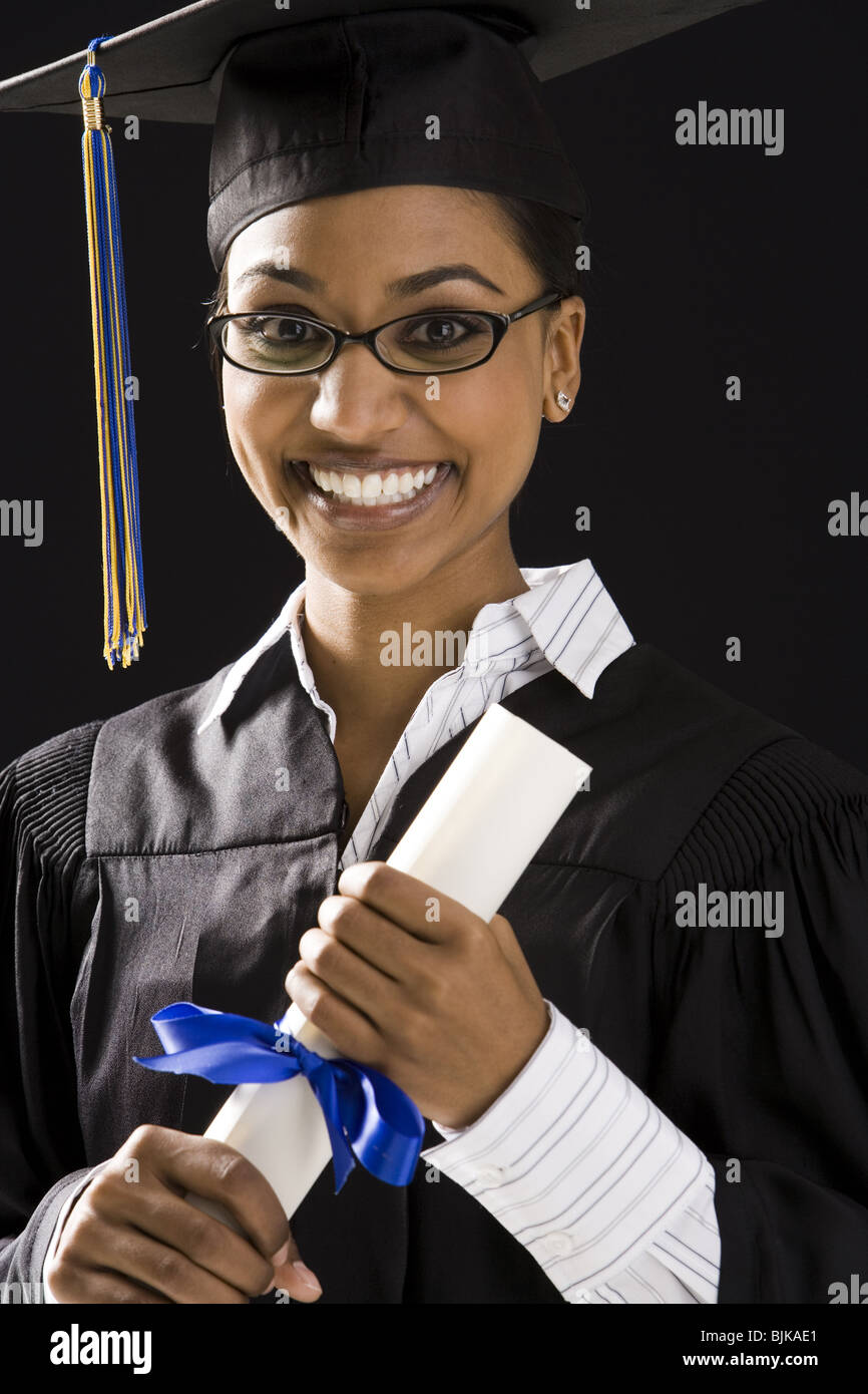 Woman in graduation gown and Blank Sign with diploma Stock Photo - Alamy