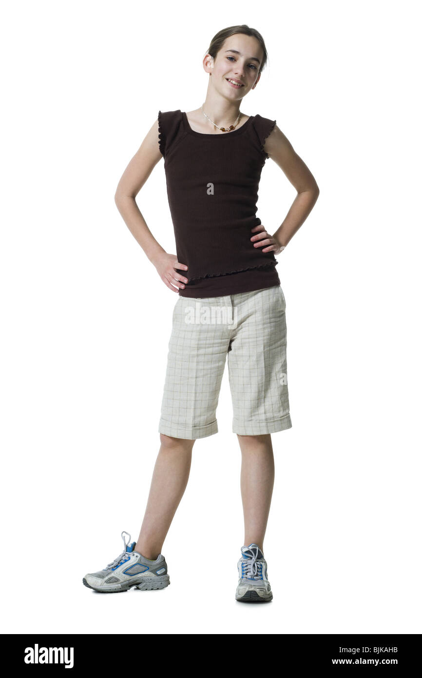 Girl standing with hands on hips Stock Photo - Alamy