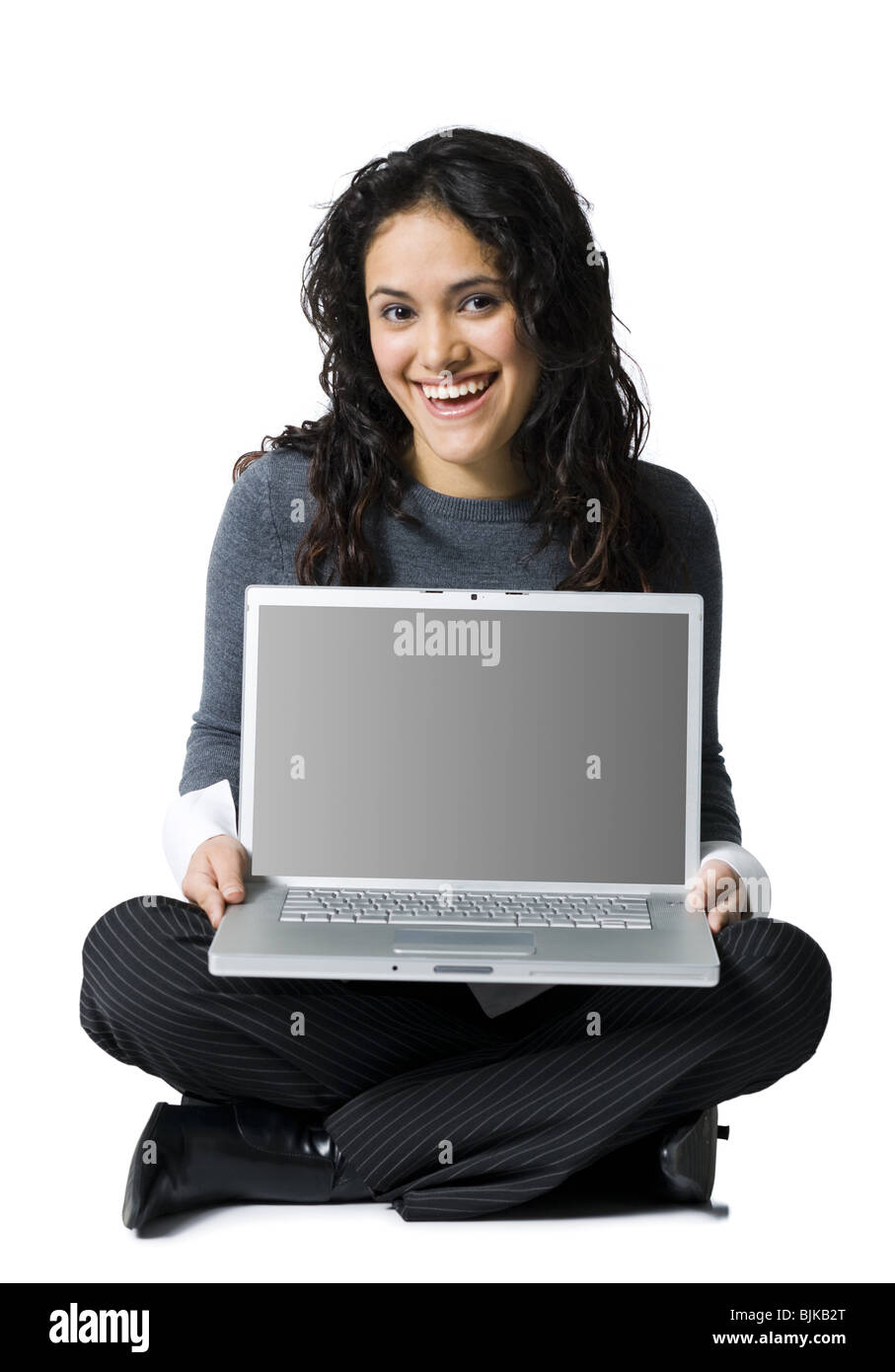 Woman sitting cross legged with laptop smiling Stock Photo Alamy