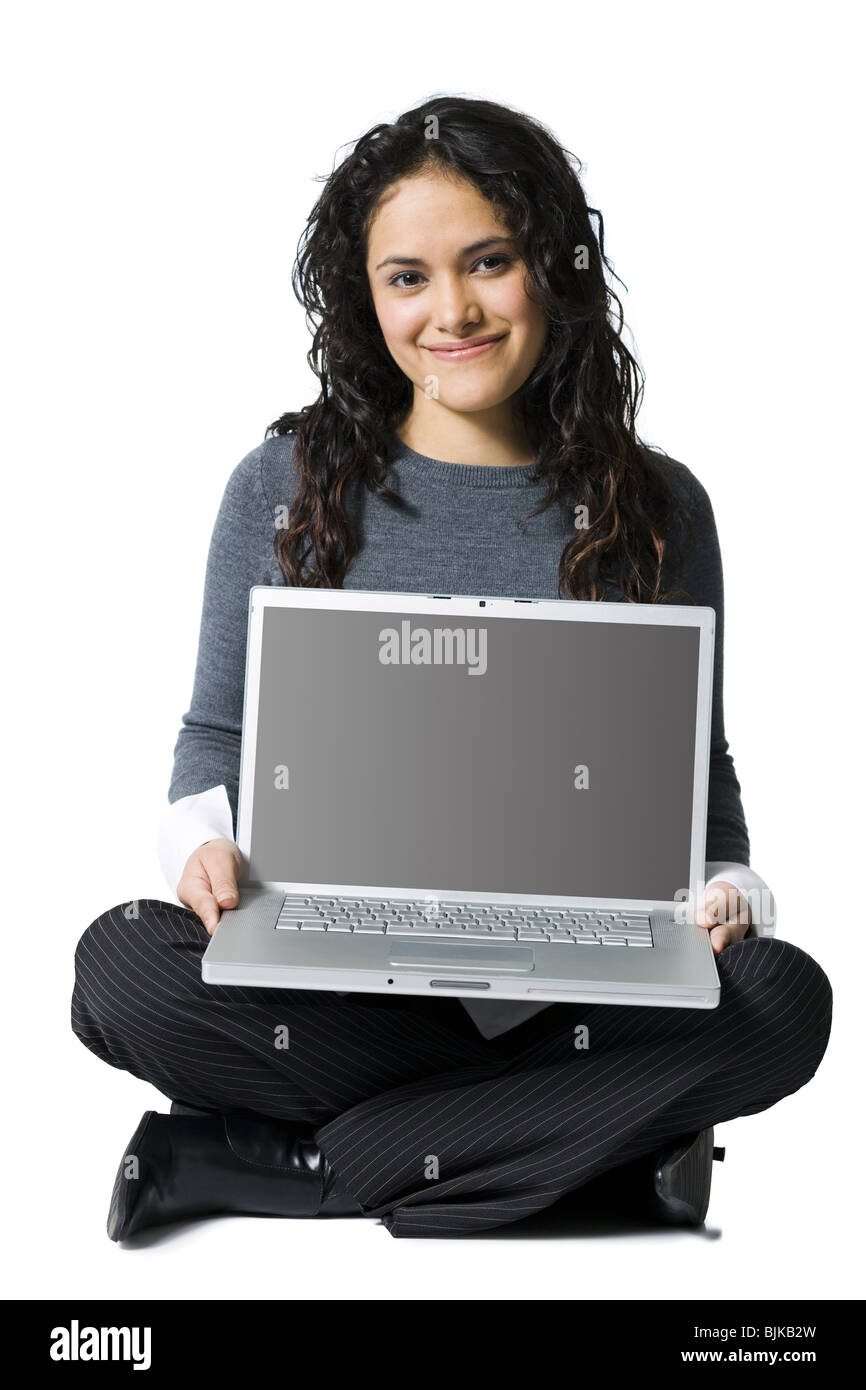 Woman sitting cross legged with laptop smiling Stock Photo Alamy