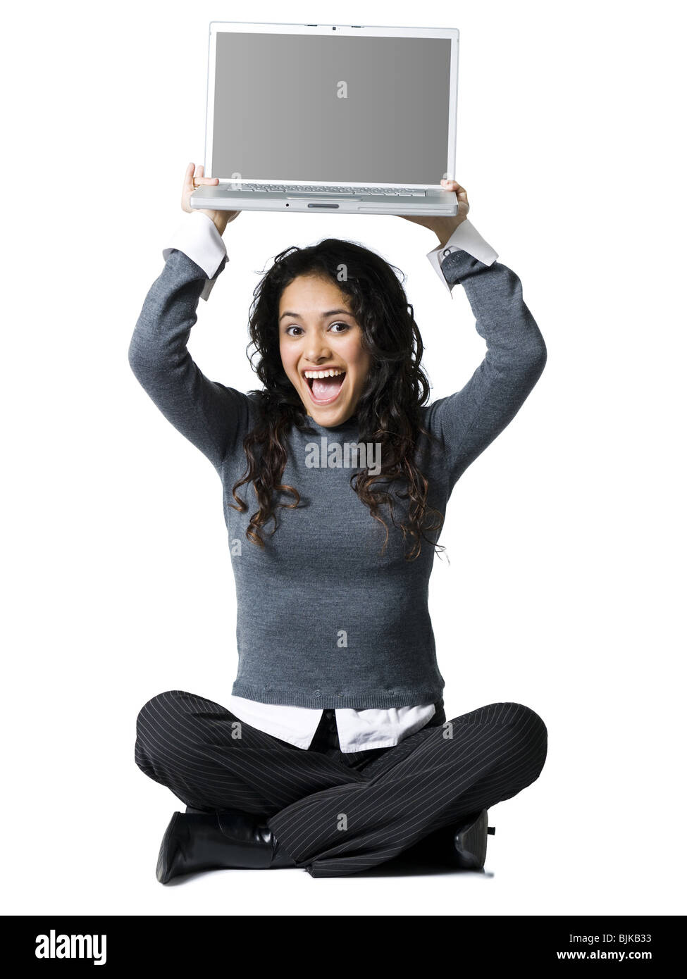 Woman sitting cross legged with laptop smiling Stock Photo Alamy