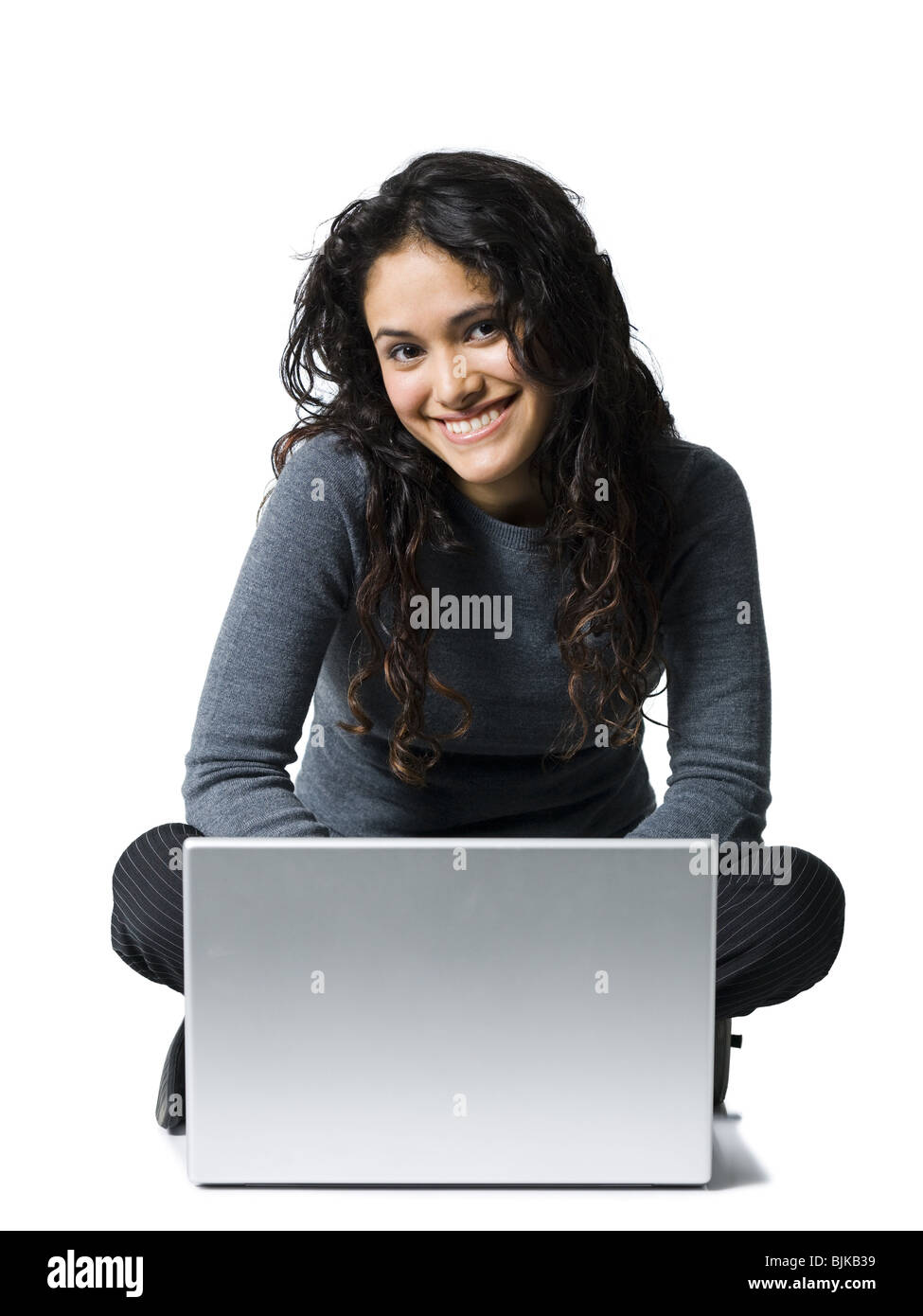 Woman sitting cross legged with laptop smiling Stock Photo Alamy