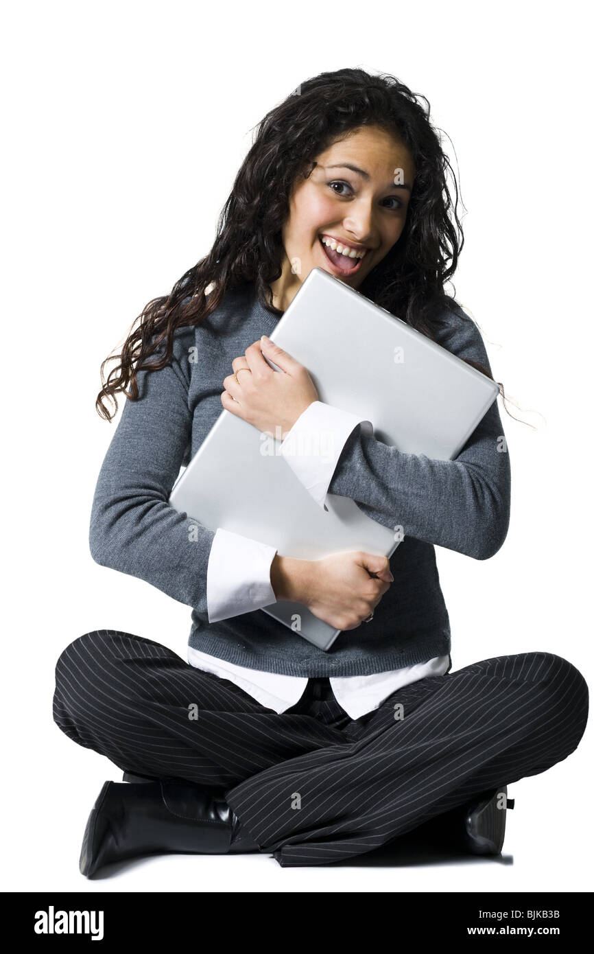 Woman sitting cross legged hugging laptop Stock Photo Alamy