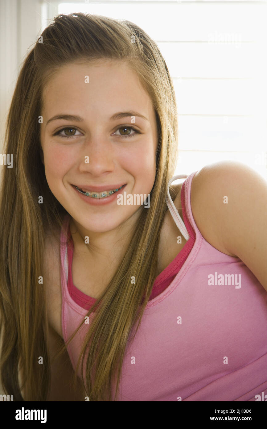 Girl With Braces On Bed With Hairbrush Smiling Stock Ph