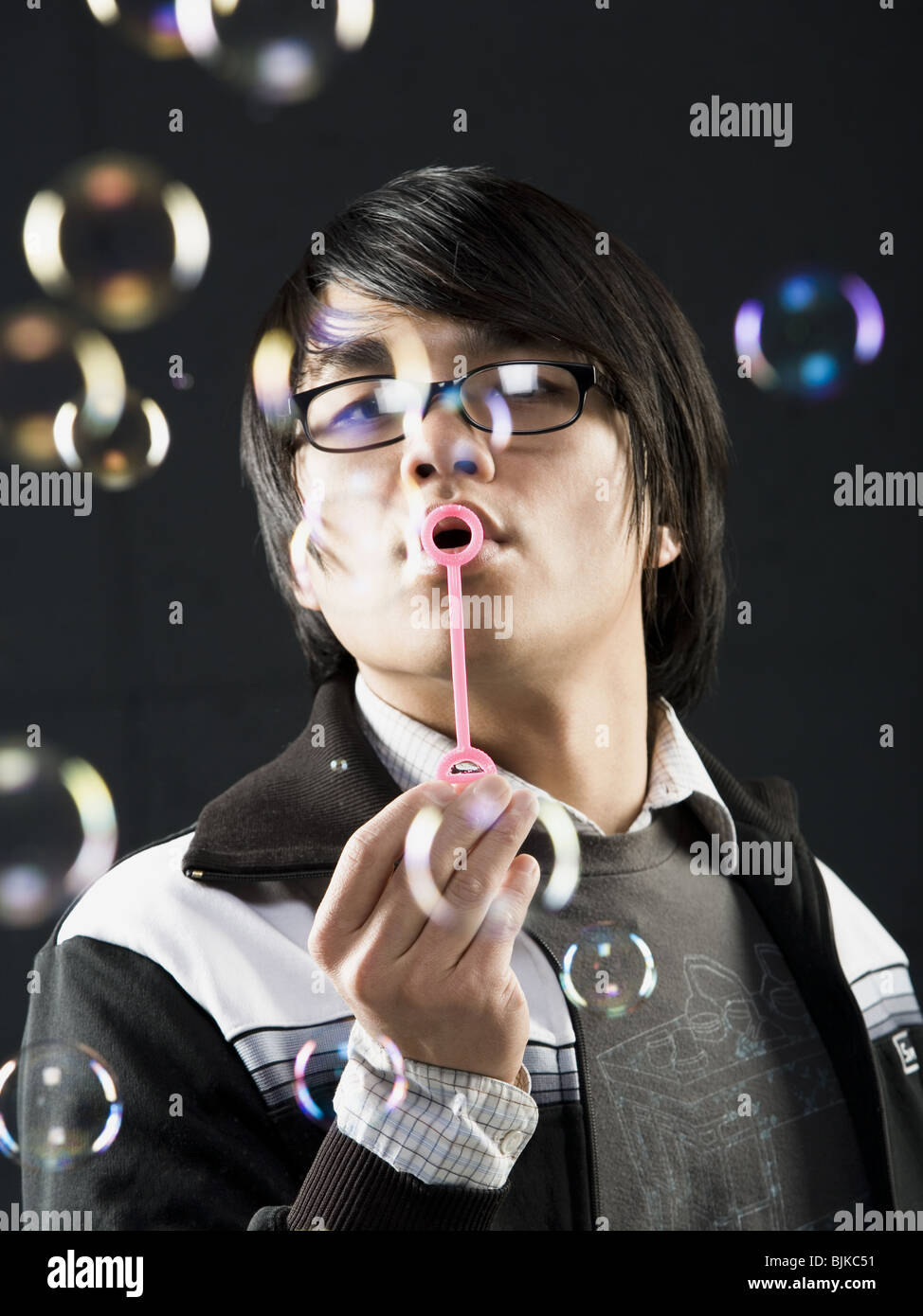 Profile of man with glasses blowing bubbles Stock Photo Alamy