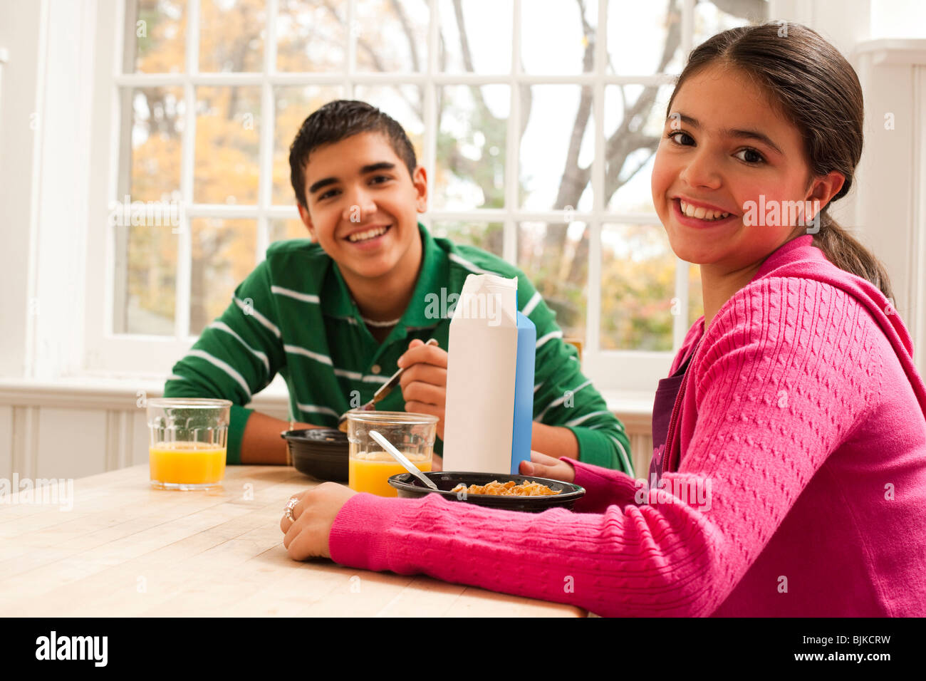 Boy and girl eating breakfast Stock Photo