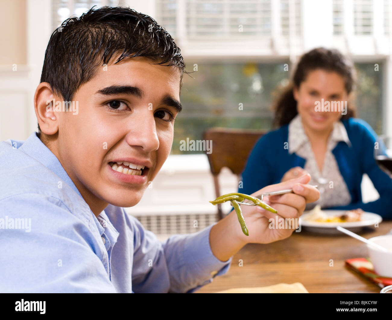 Boy eating green beans Stock Photo Alamy