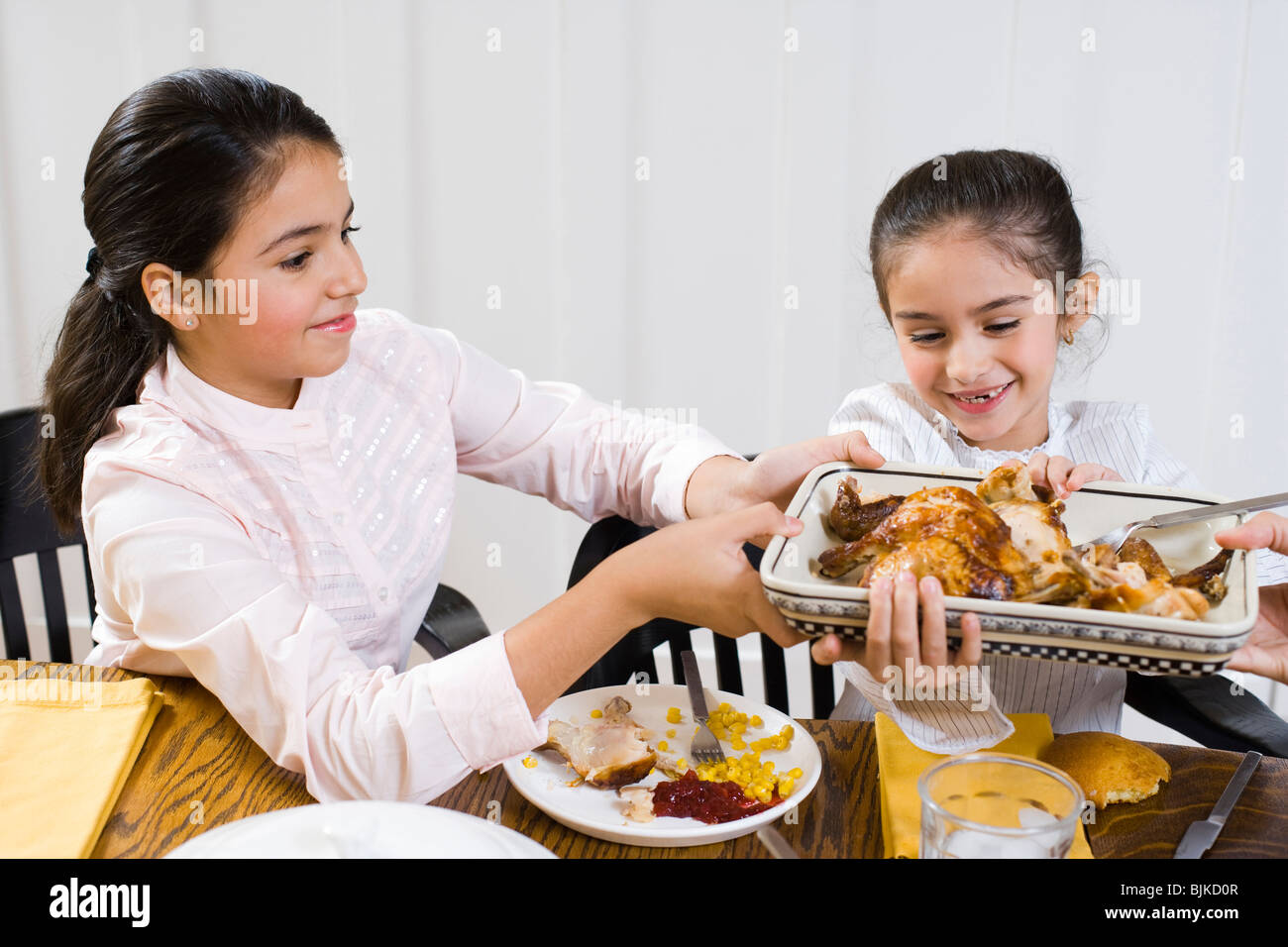 Family at dinner table smiling Stock Photo