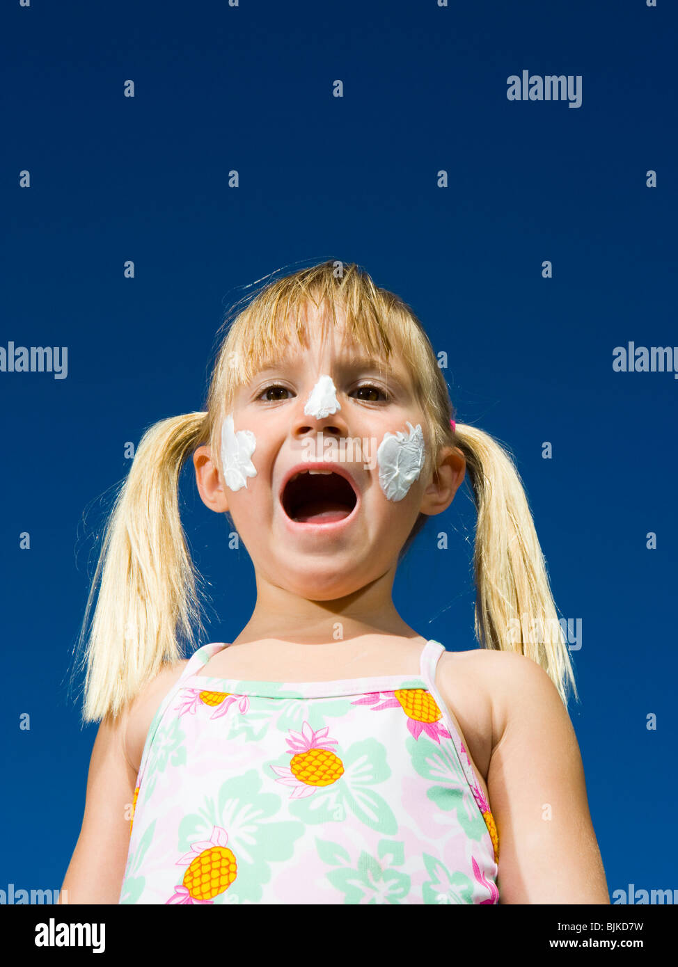 Boy and girl with sunscreen shouting Stock Photo