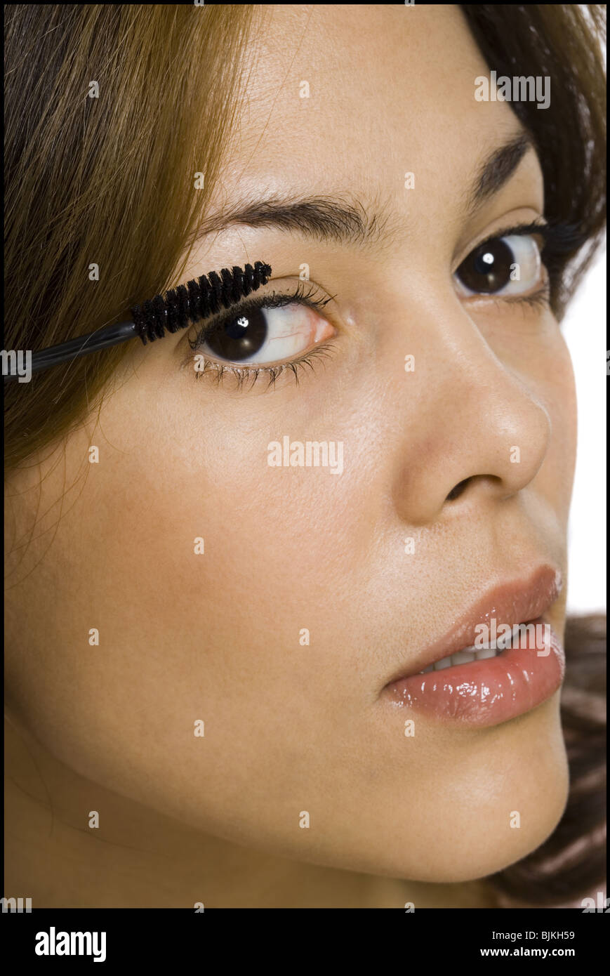 Closeup of woman applying mascara Stock Photo