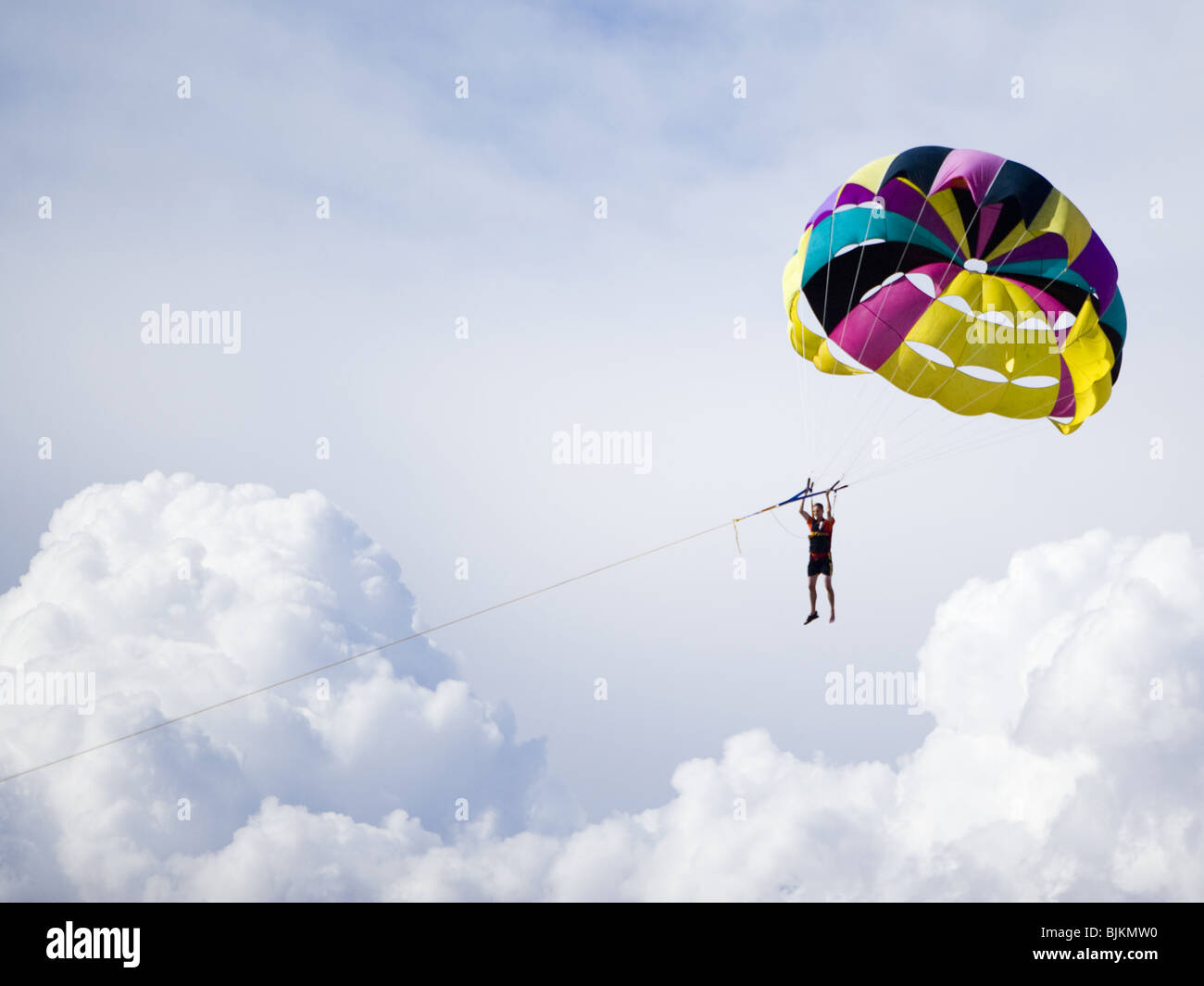 Man with parachute floating Stock Photo