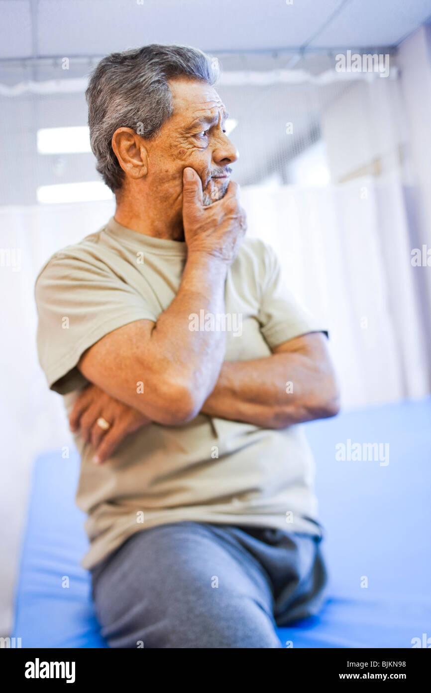 Man with one leg sitting with arms crossed Stock Photo Alamy