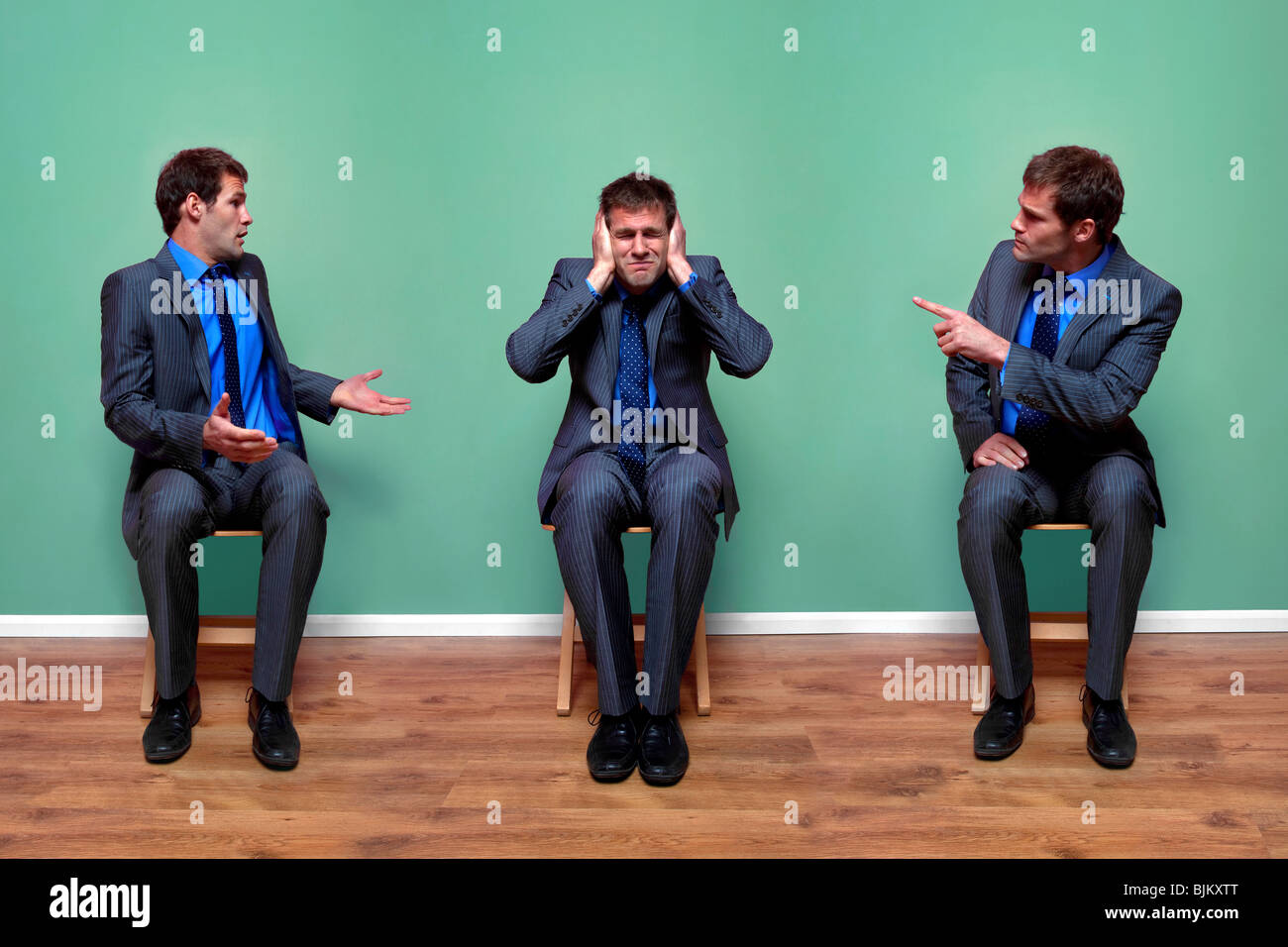 Concept image of a businessman having an argument with himself Stock Photo