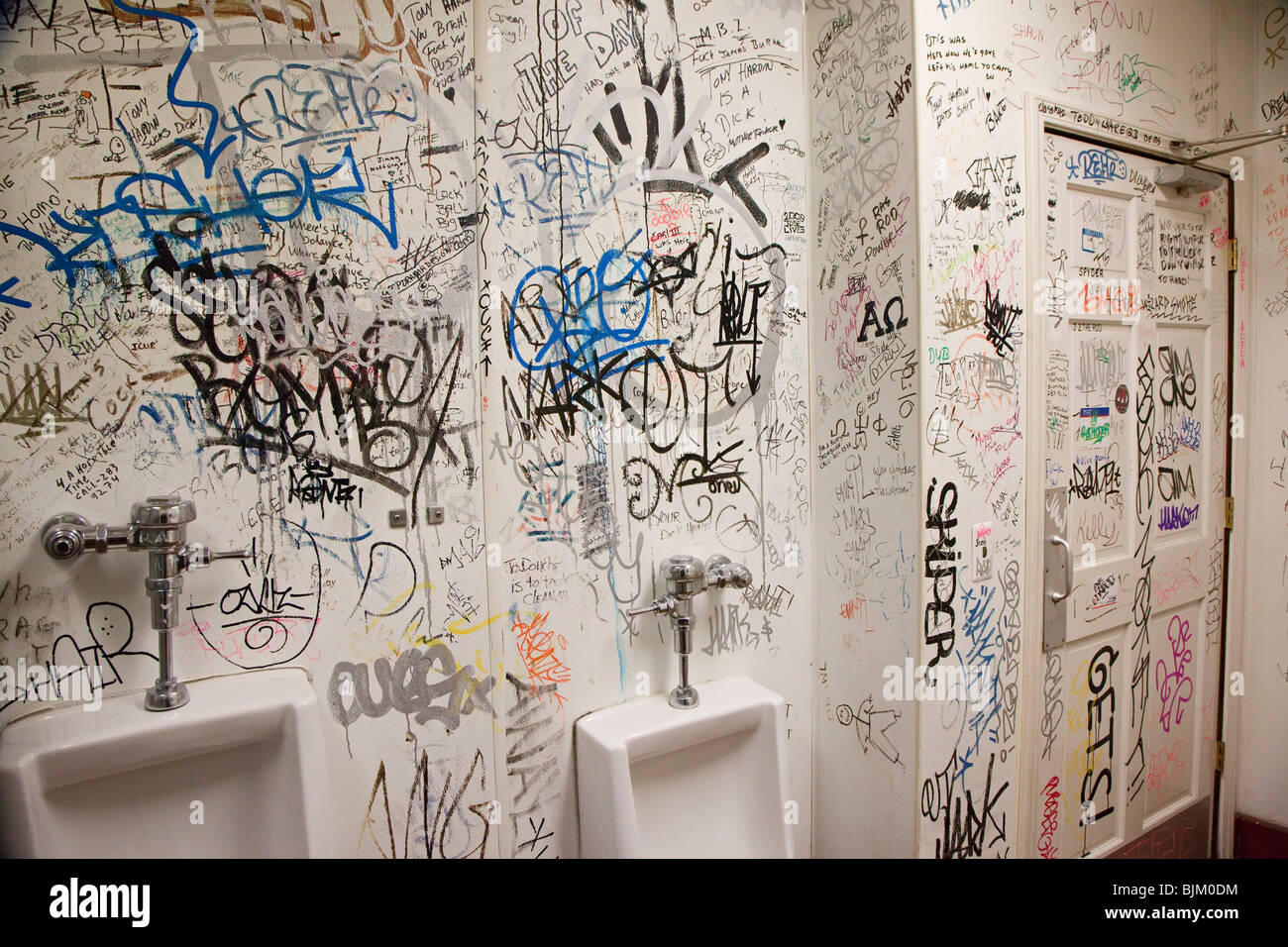 Detroit, Michigan - Graffiti covers the walls of a rest room at Honest ? John's Bar and No Grill. Stock Photo