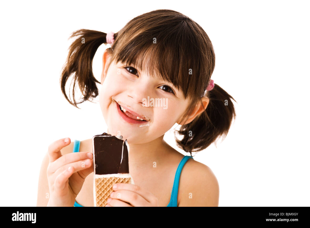 Little girl with pigtails eating ice cream Stock Photo