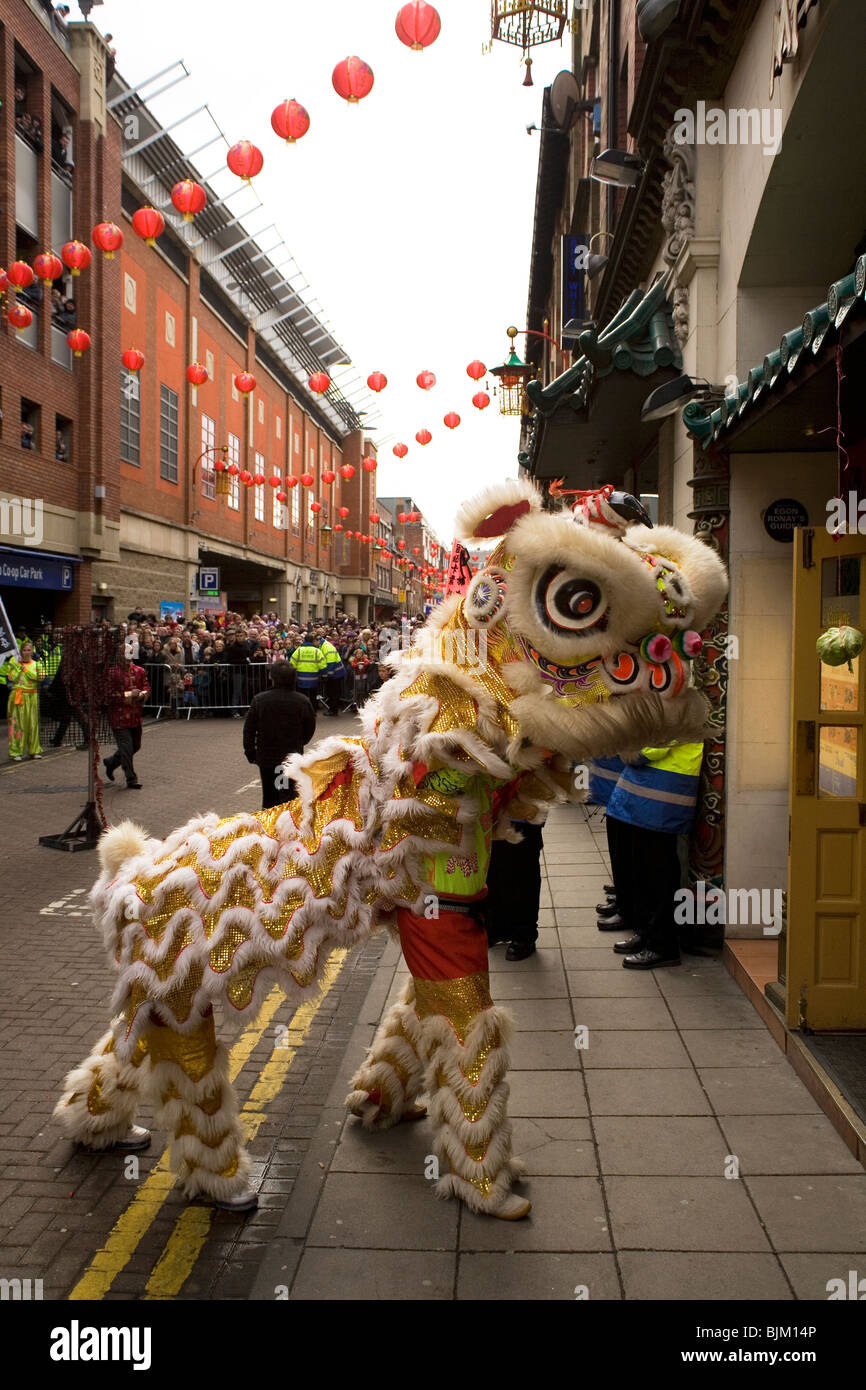 A dragon dances outside of restaurants as part of Chinese New Year celebrations in Chinatown at Newcastle-upon-Tyne, England. Stock Photo