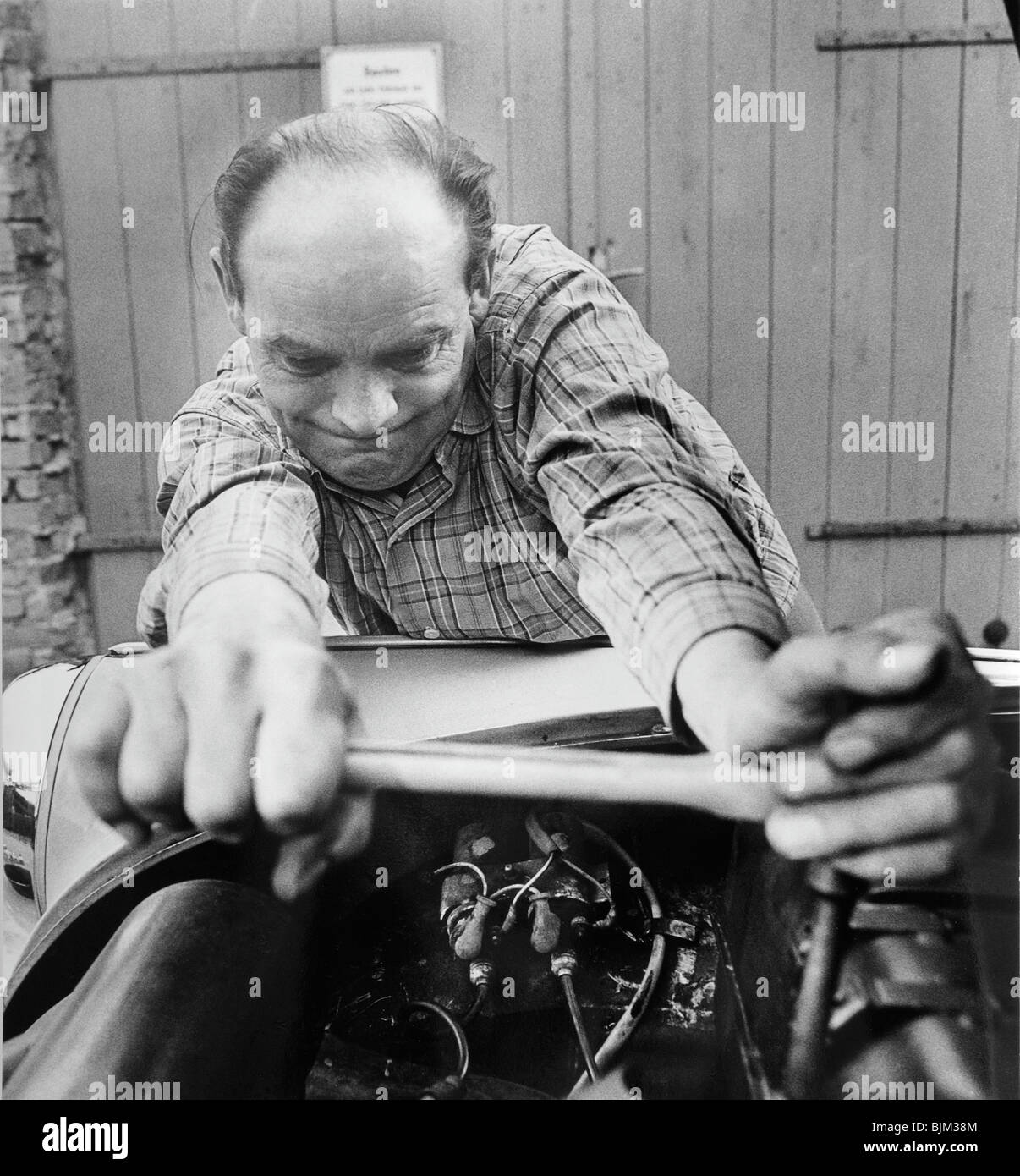 Man repairing a Trabant 600, East Germany, Europe, circa 1975 Stock Photo