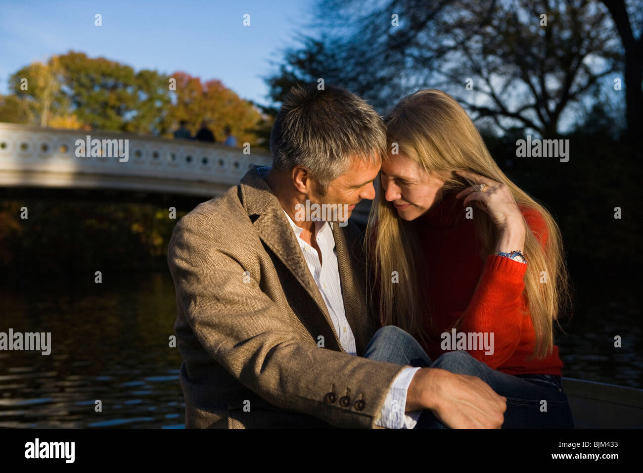 Couple hugging on bridge in hi-res stock photography and images - Alamy
