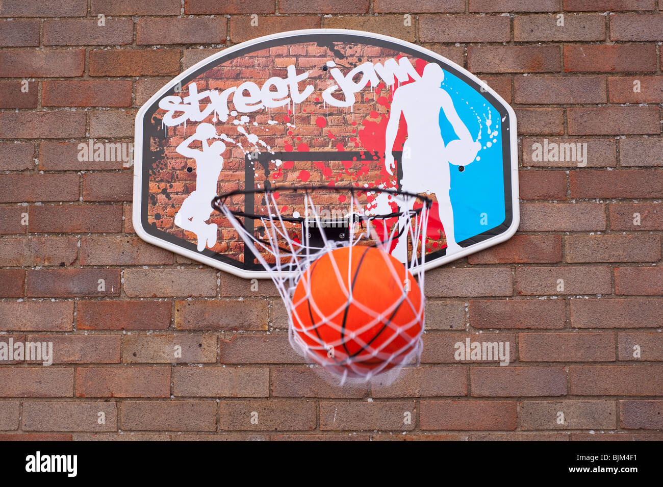 A basketball goes through the hoop net scoring a point Stock Photo Alamy