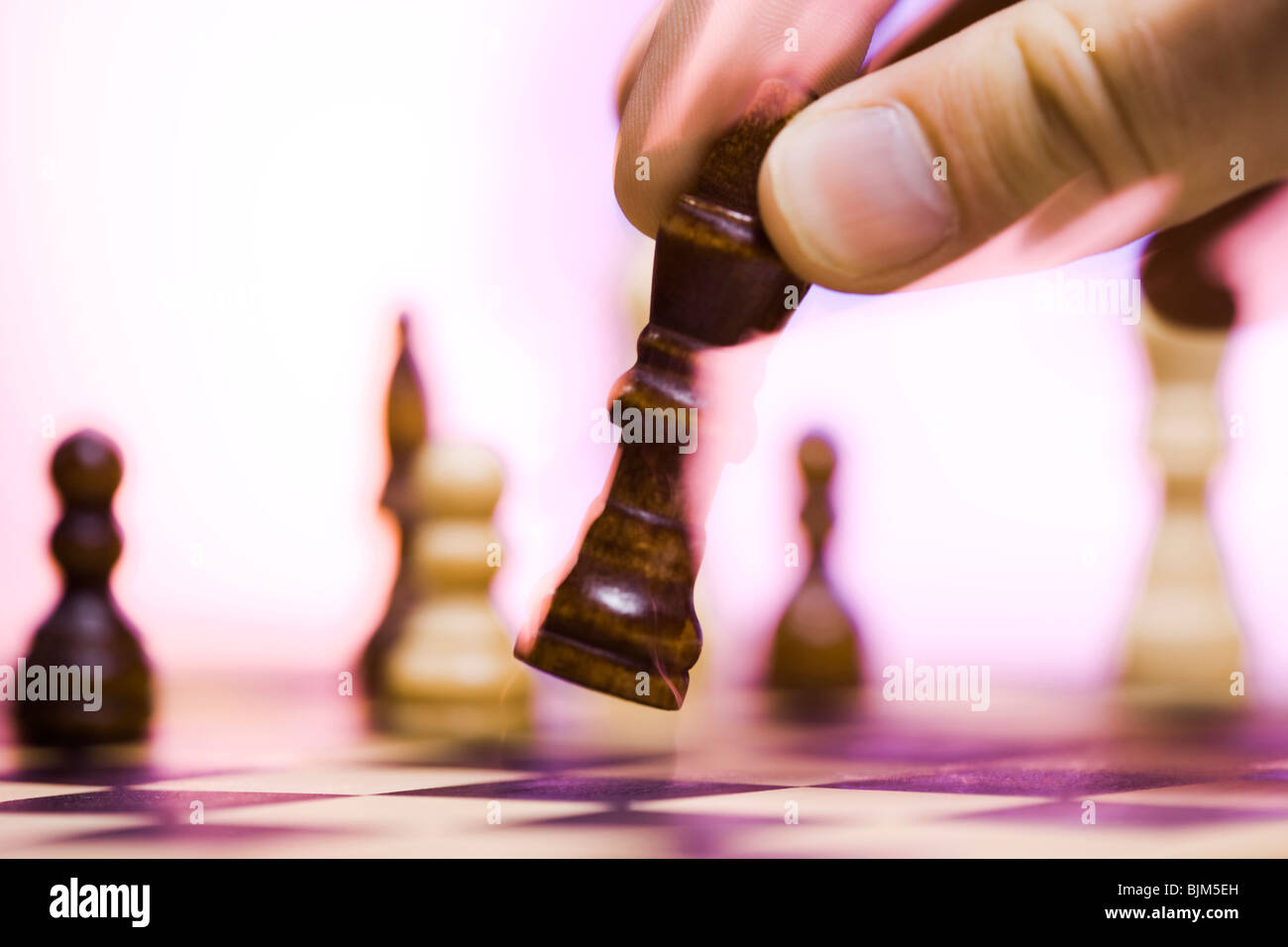 Bishop Chess Piece being moved Stock Photo