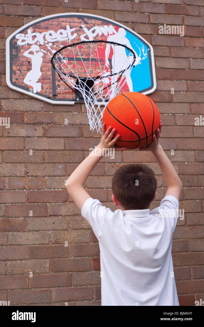 A MODEL RELEASED picture of a 10 year old boy playing basketball in the