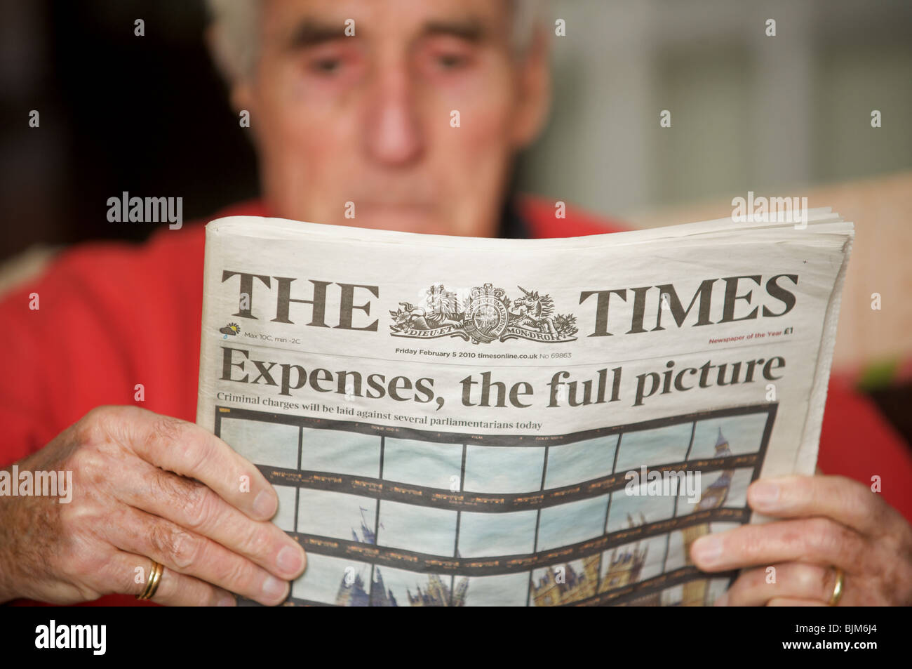 Elderly gentleman reading The Times newspaper with the headline, Expenses, the full picture. Stock Photo