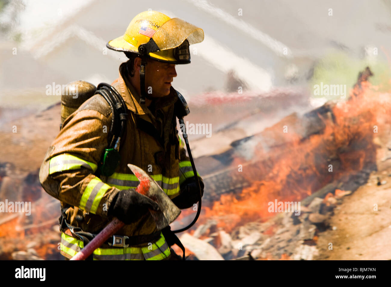 Portrait of a firefighter with axe Stock Photo Alamy
