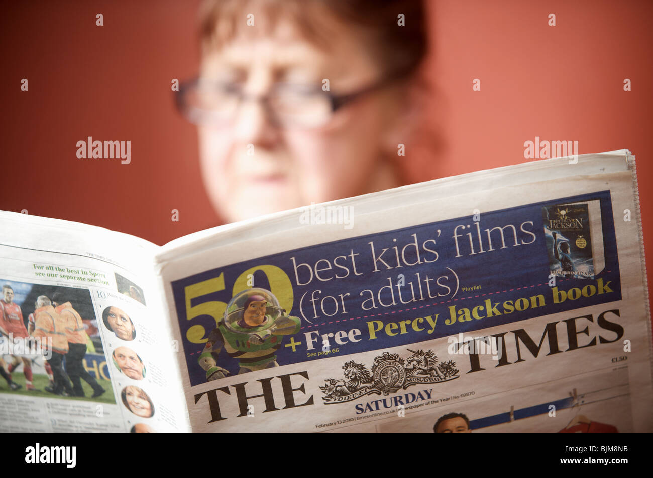 Woman reading a copy of The Times newspaper. Stock Photo