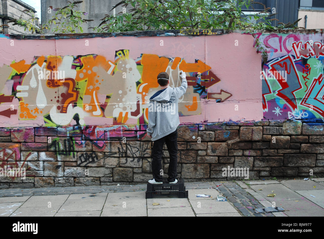 Graffiti artist working on the legal boards in Potterrow Edinburgh