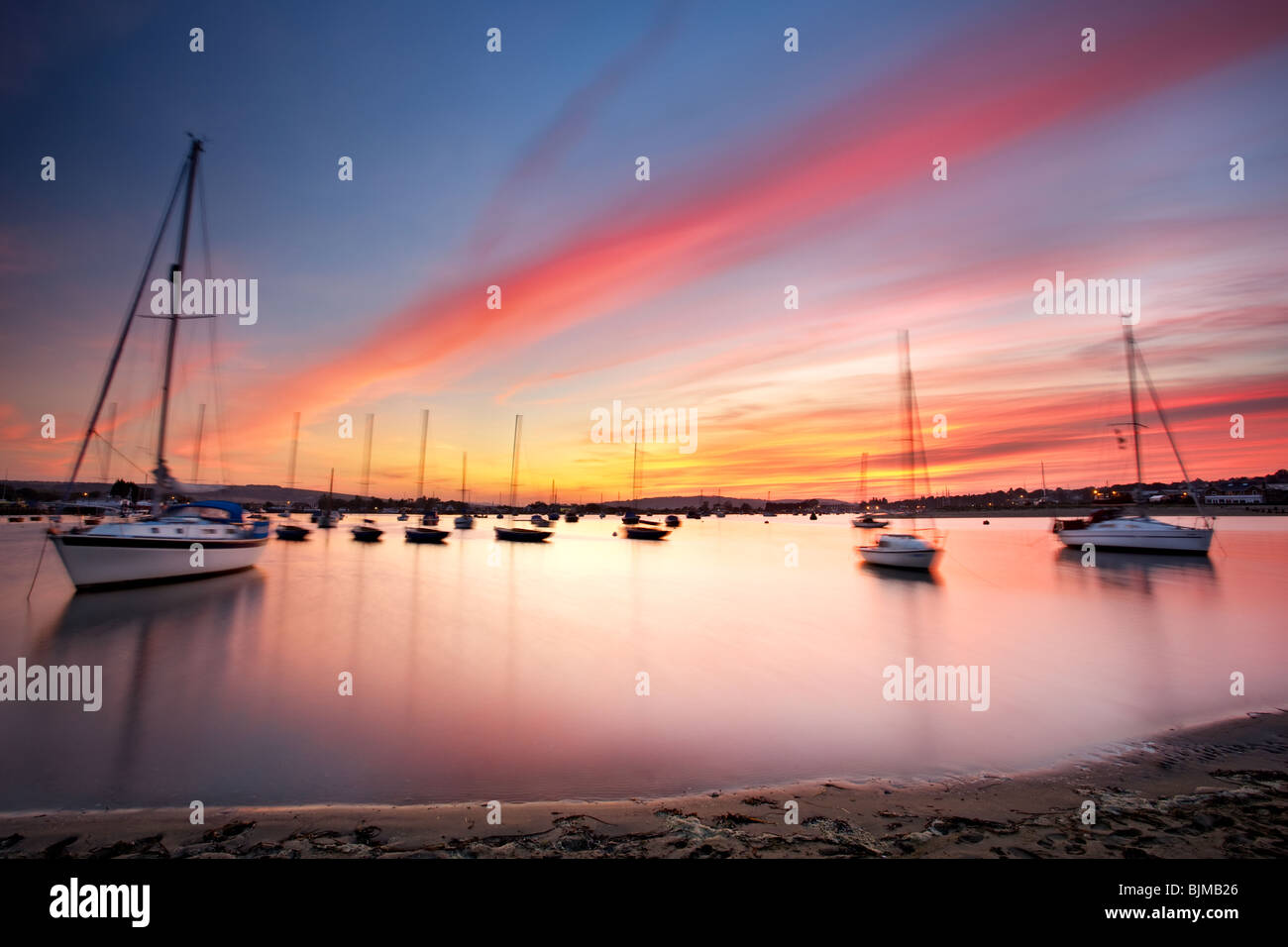 Sun setting over boats in Bembridge Harbour. Isle of Wight, England, UK Stock Photo